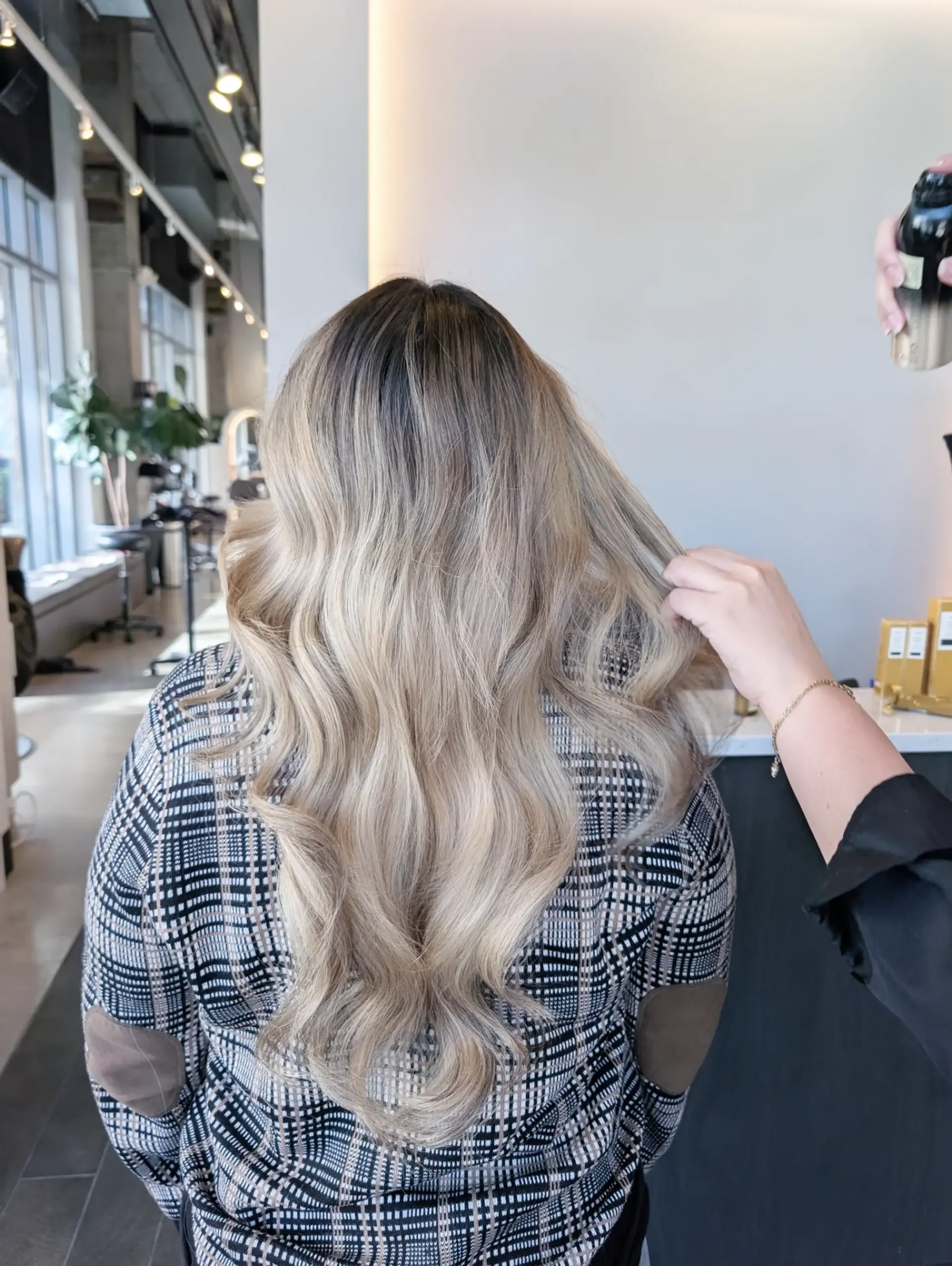 Long cascading waves featuring a cool ash blonde foilayage seamlessly blended with a soft dark shadow root. 1