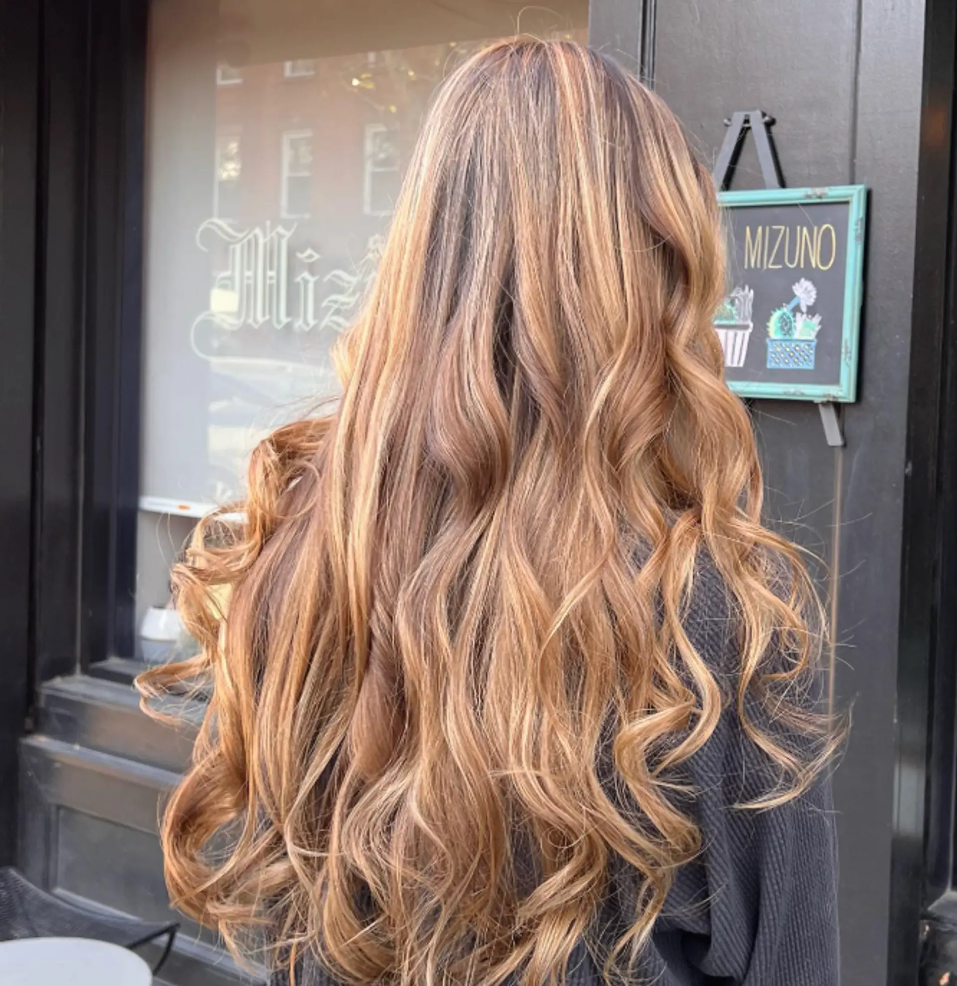 Long, wavy hairstyle with caramel swirl highlights and balayage. 1