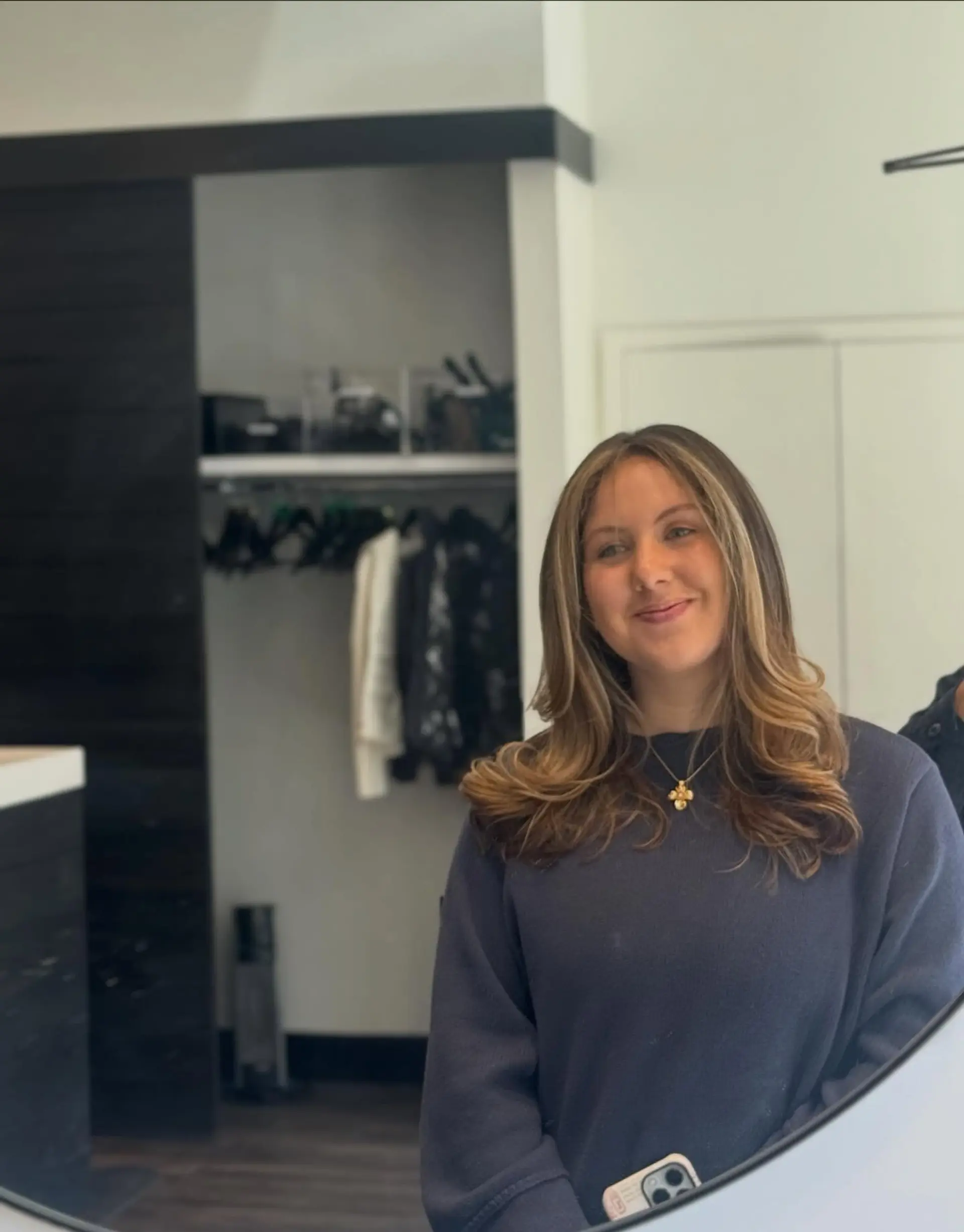 Medium-to-long layered brunette hair styled into a voluminous blowout with flipped curved ends and soft blonde face-framing highlights. 1