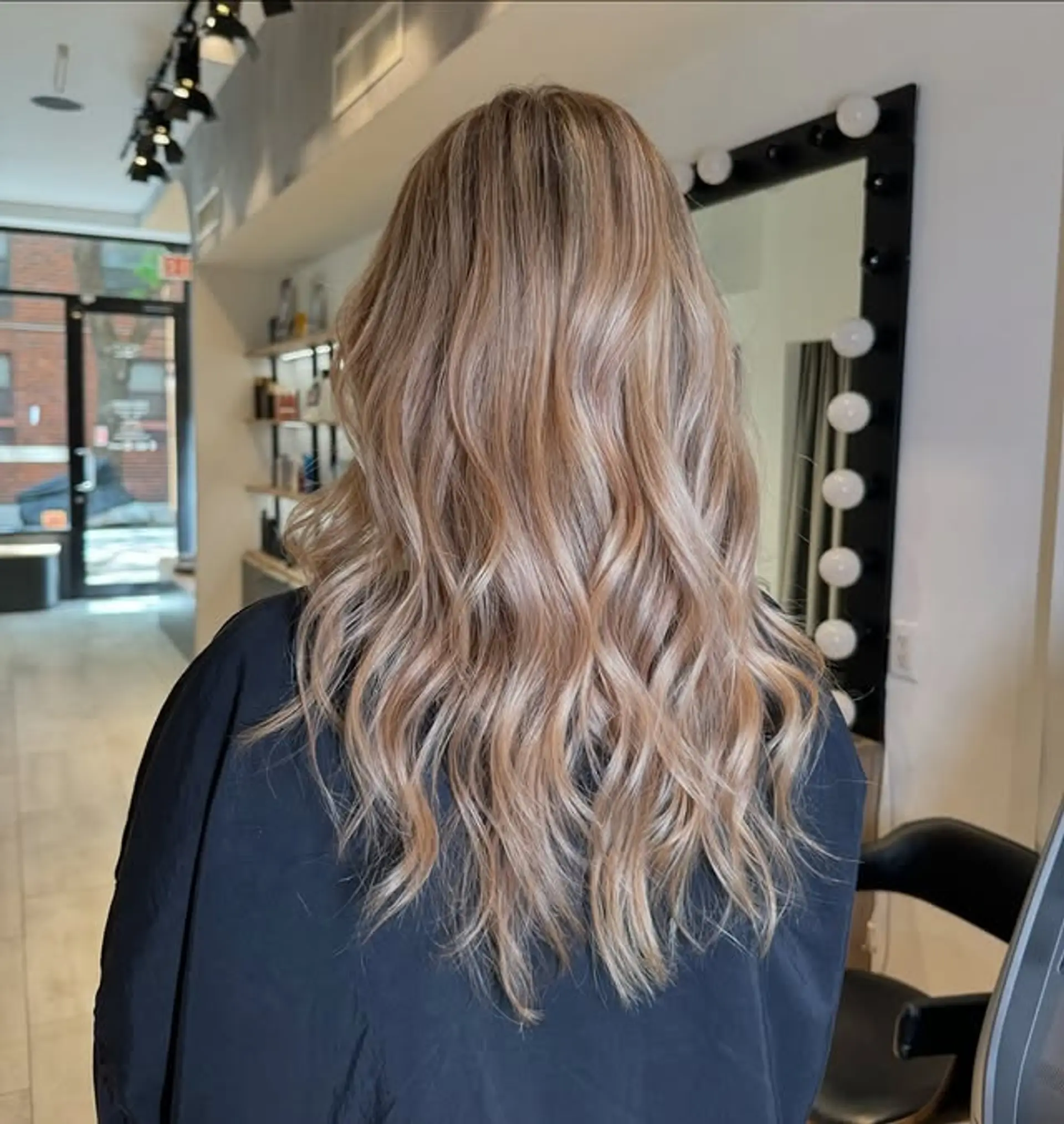 Long, wavy hair with sun-kissed balayage. 1