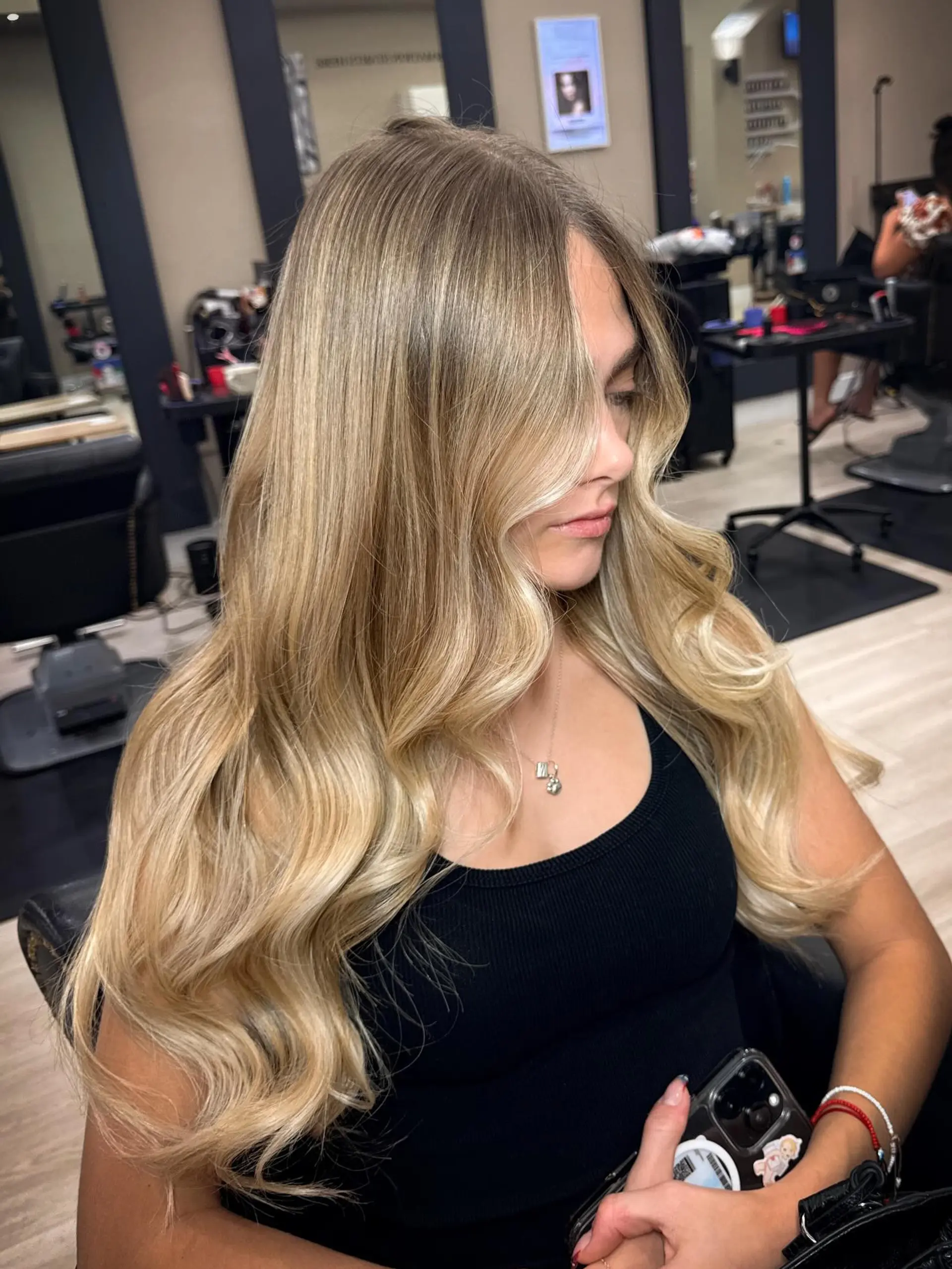 Long, luminous dimensional blonde hair styled in smooth, voluminous cascading waves. 1