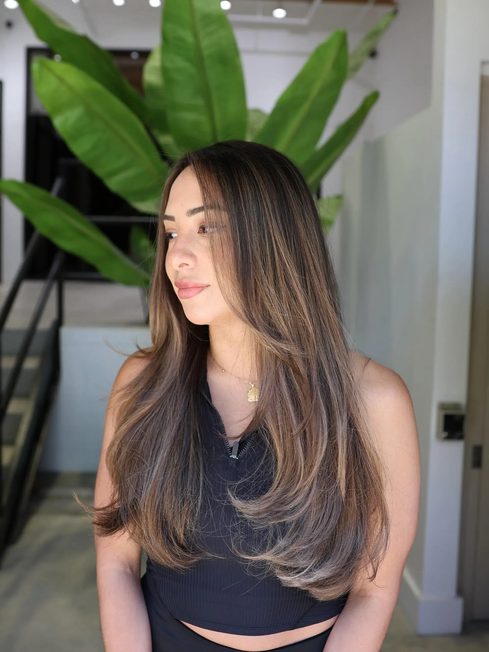 Long, layered hairstyle with subtle waves and face-framing layers. 2