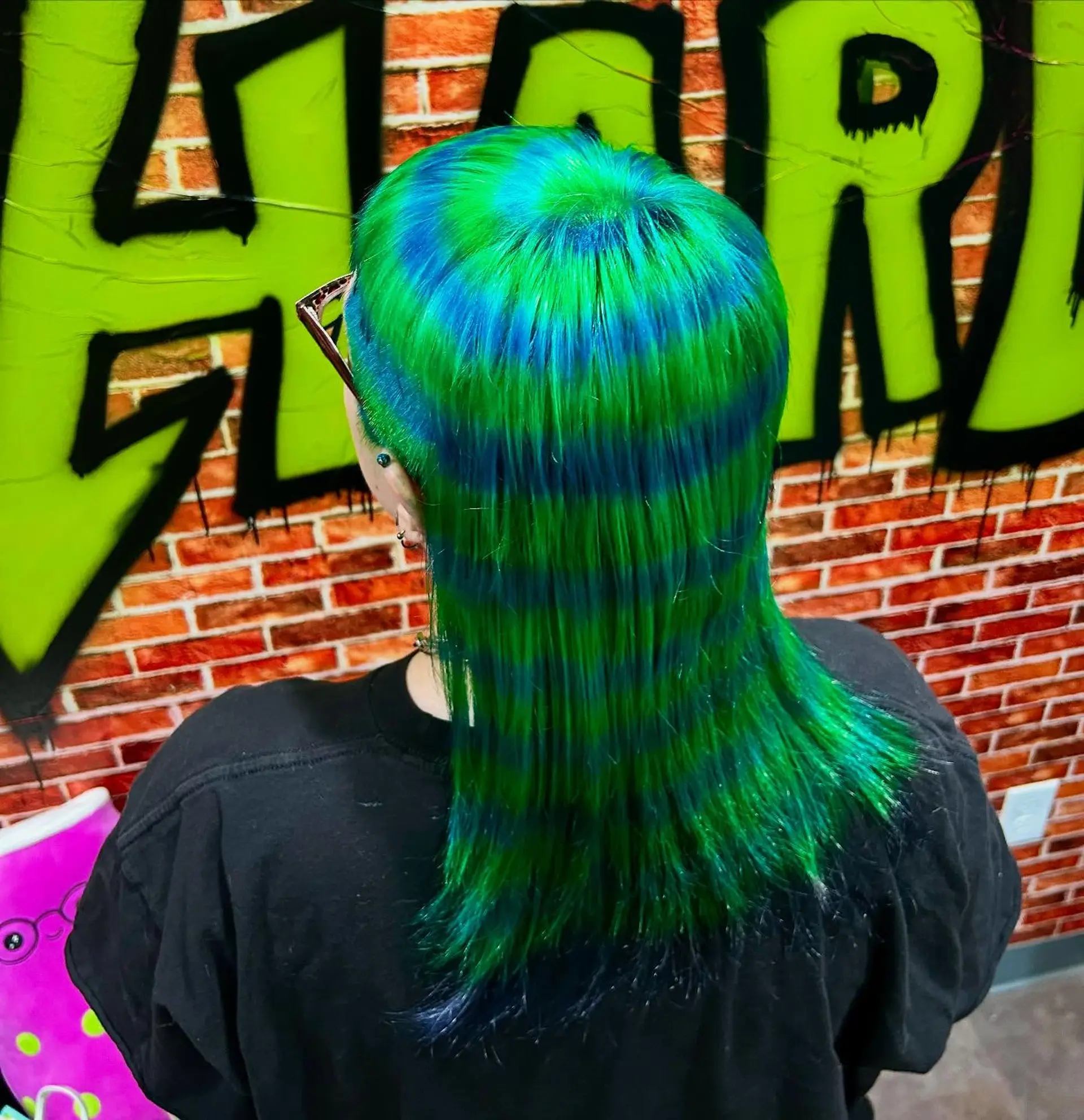 A straight medium-length style featuring an intricate hypnotic spiral pattern dyed in vibrant neon green and electric blue. 1