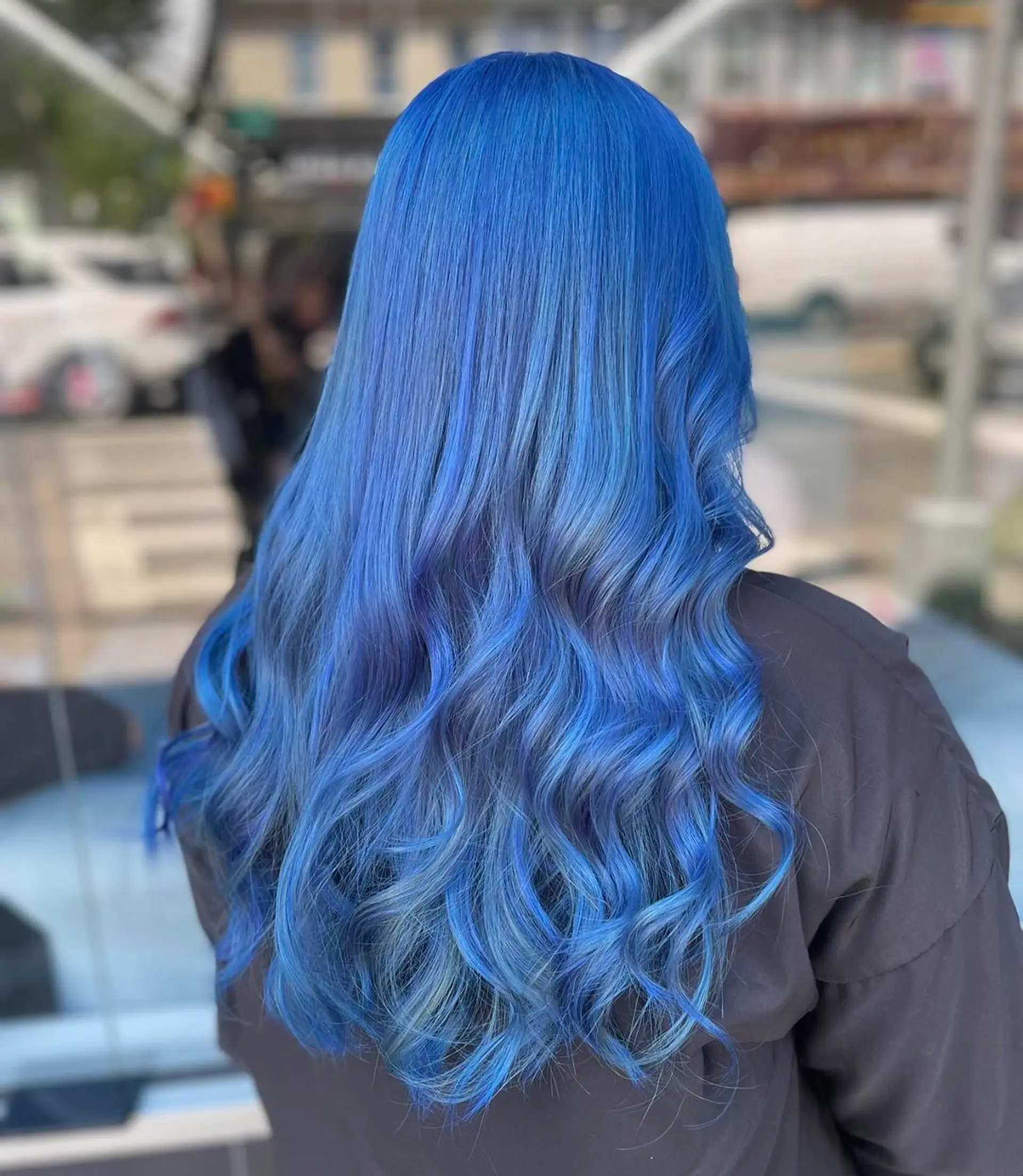 Long, wavy hair with a gradient effect of blue hues, styled in relaxed, loose waves and a layered cut, featuring a glossy finish.
Stylist - @xcellent_jason 2