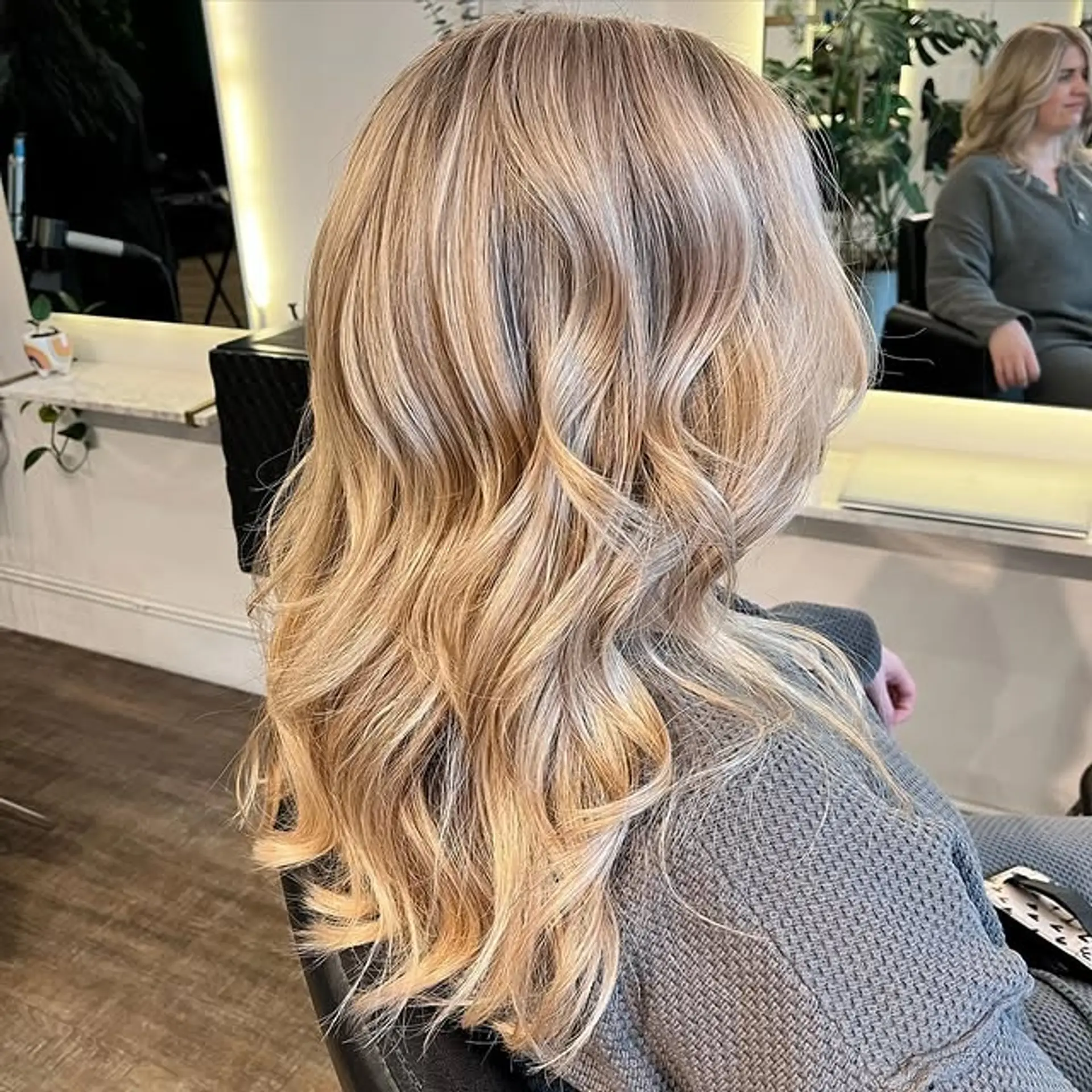 Long, wavy blonde hair with layers and a balayage effect. 1