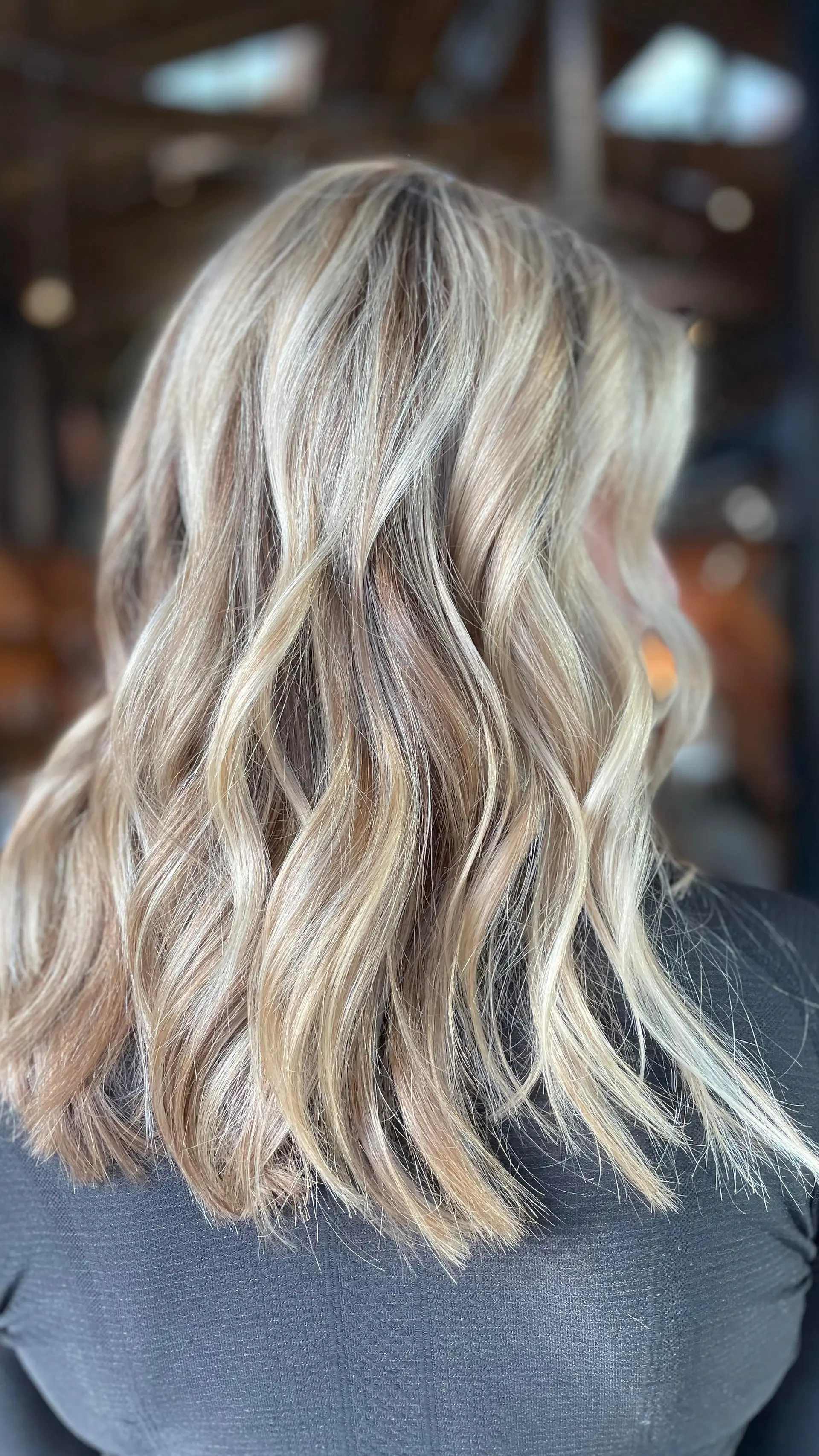 Medium-length lived-in blonde hair styled in loose, textured waves. 1