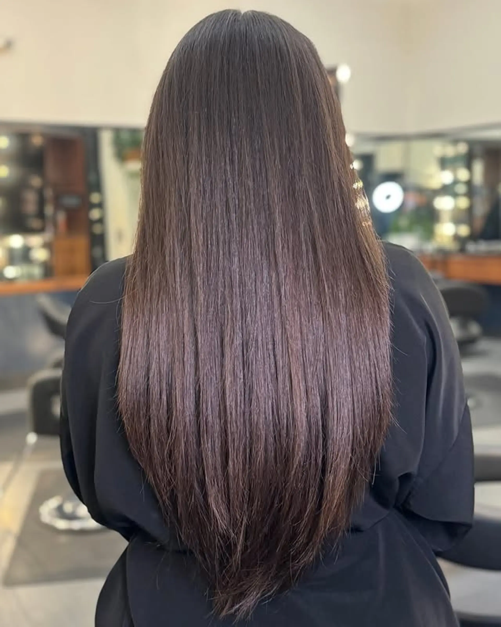 Long layered hairstyle with a V-cut at the ends. 1