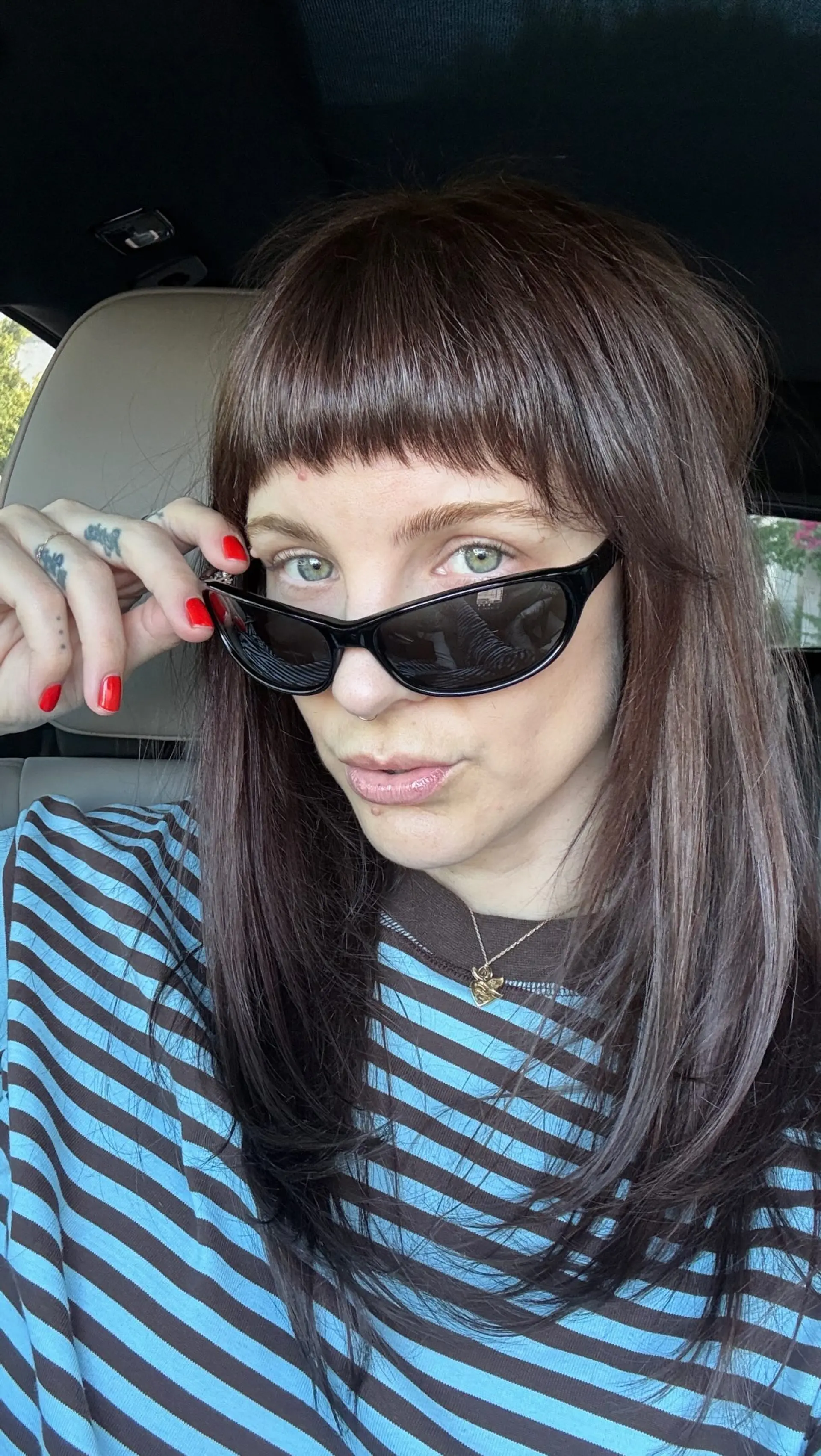 Medium-length straight dark brown hair styled with face-framing layers and blunt micro bangs. 1