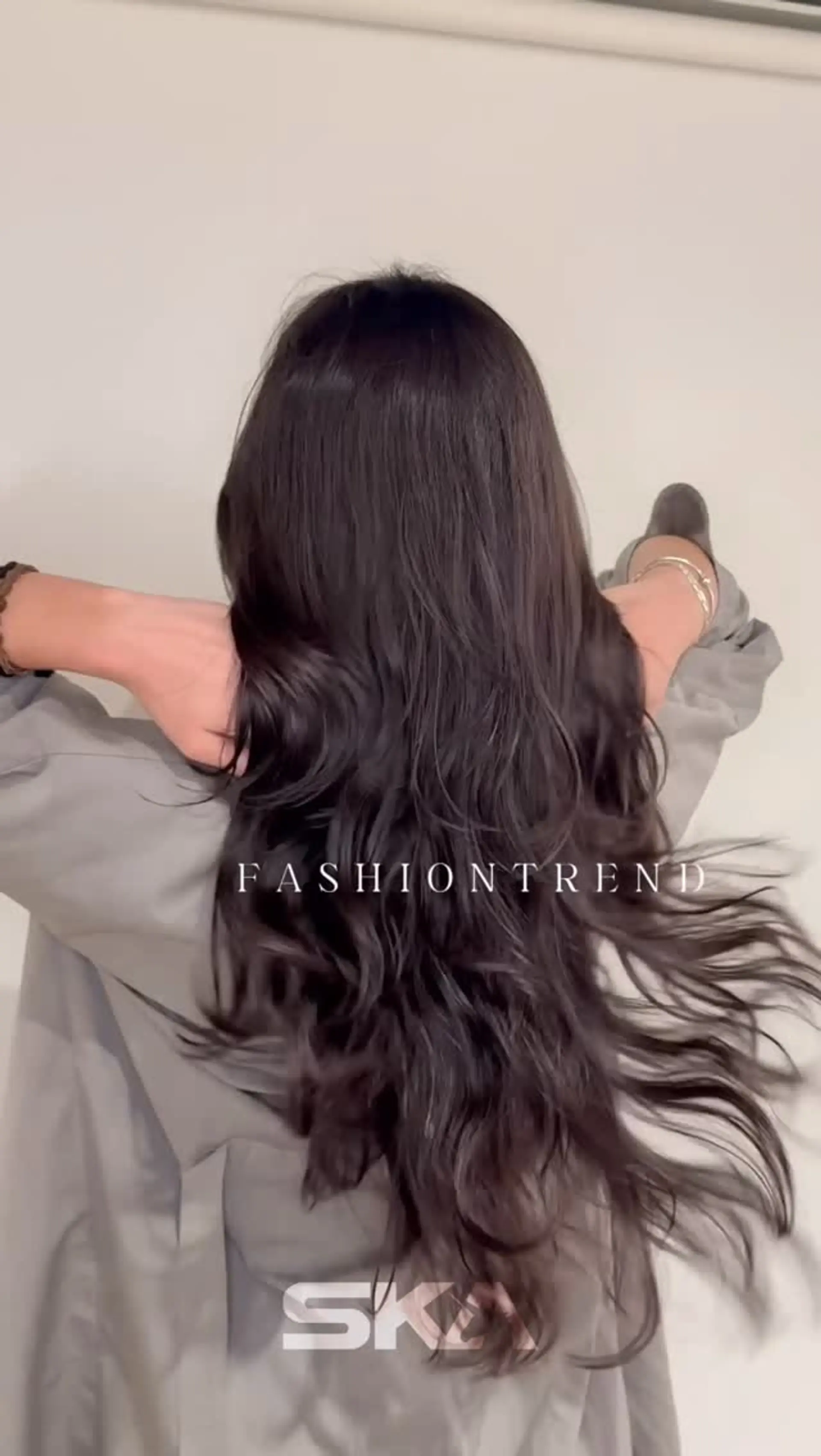 Long dark hair styled with soft, natural-looking cascading waves and textured ends. 1