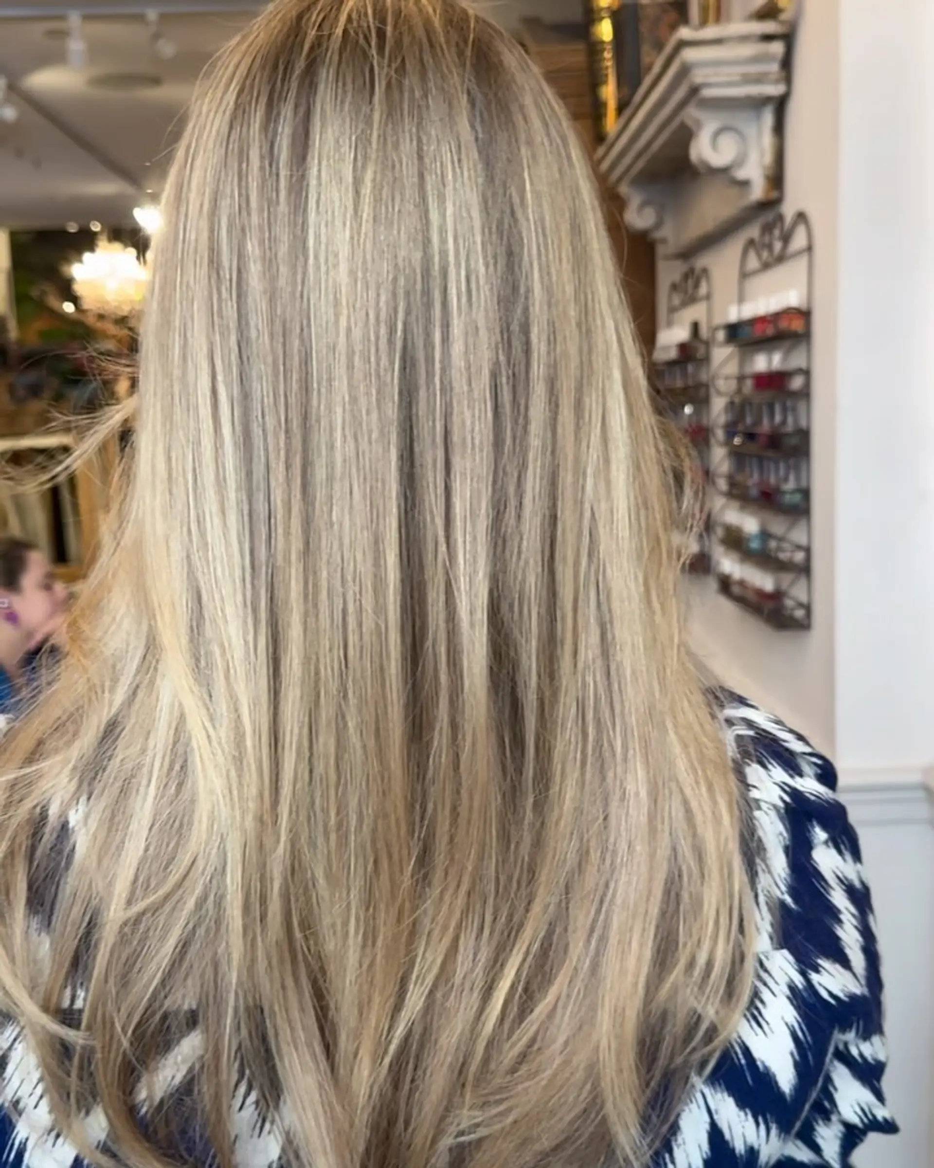 Long, straight, layered hair in golden blonde with highlights and a natural shine. 3