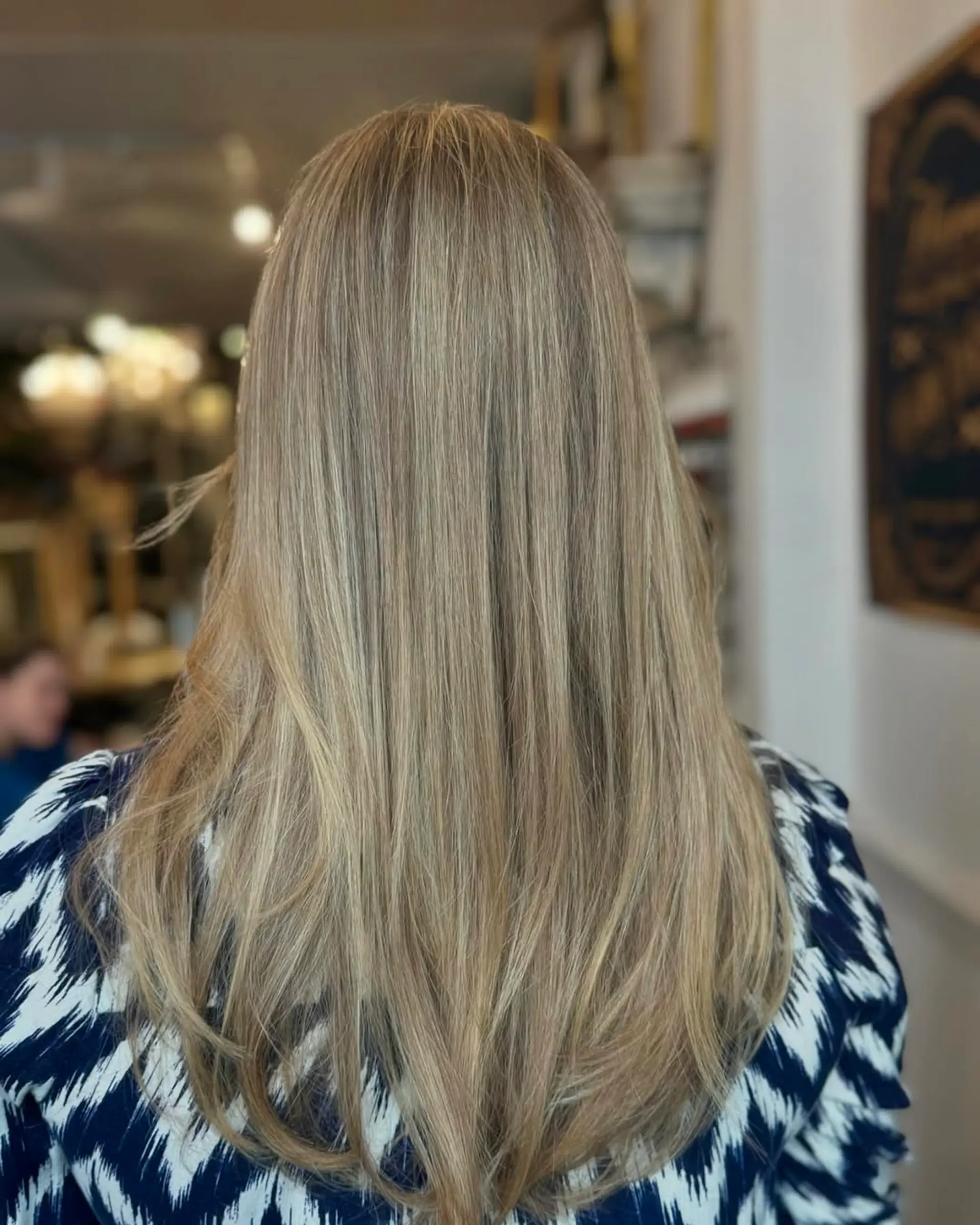 Long, straight, layered hair in golden blonde with highlights and a natural shine. 2