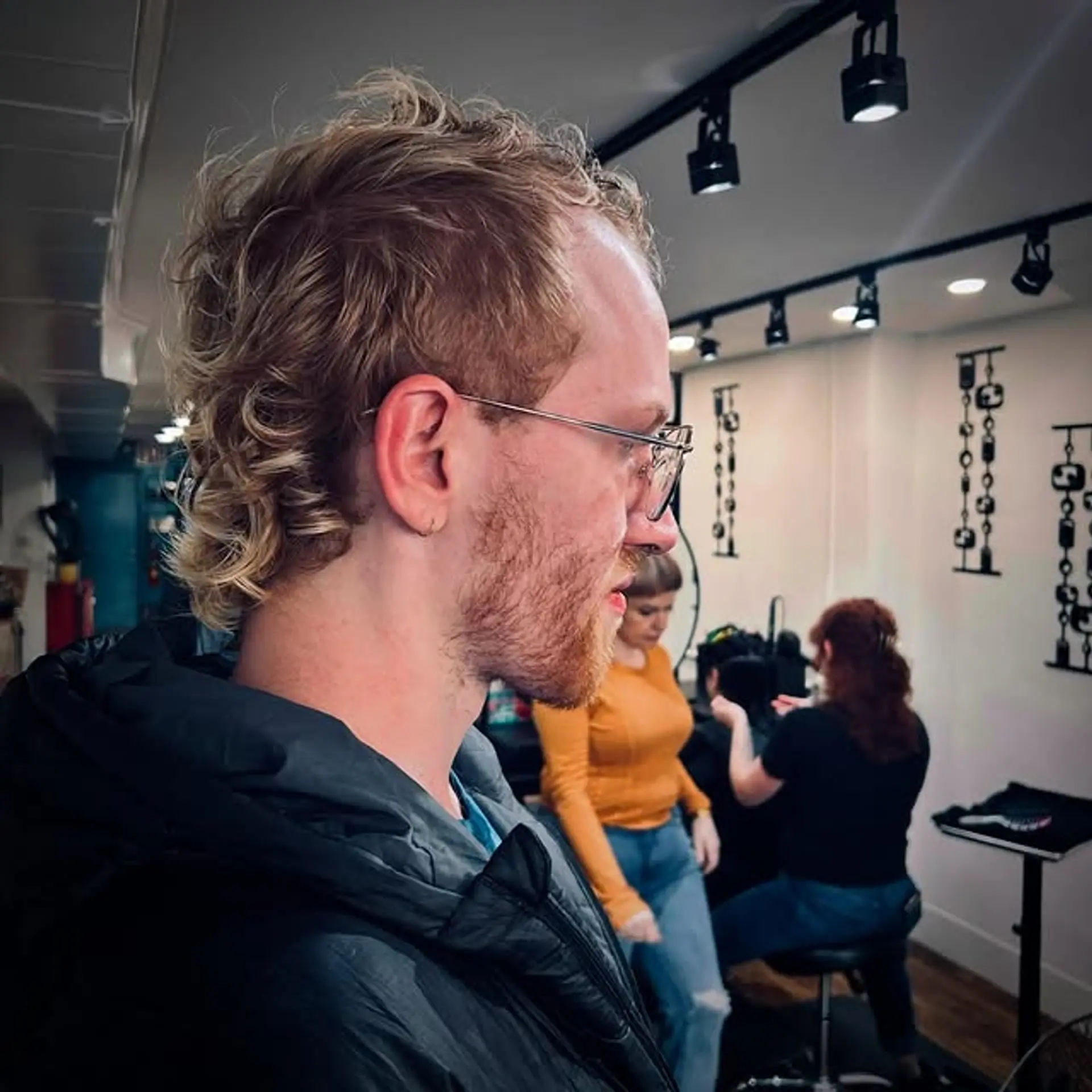 A curly mullet with shorter hair in the front and longer, curly hair in the back. 1