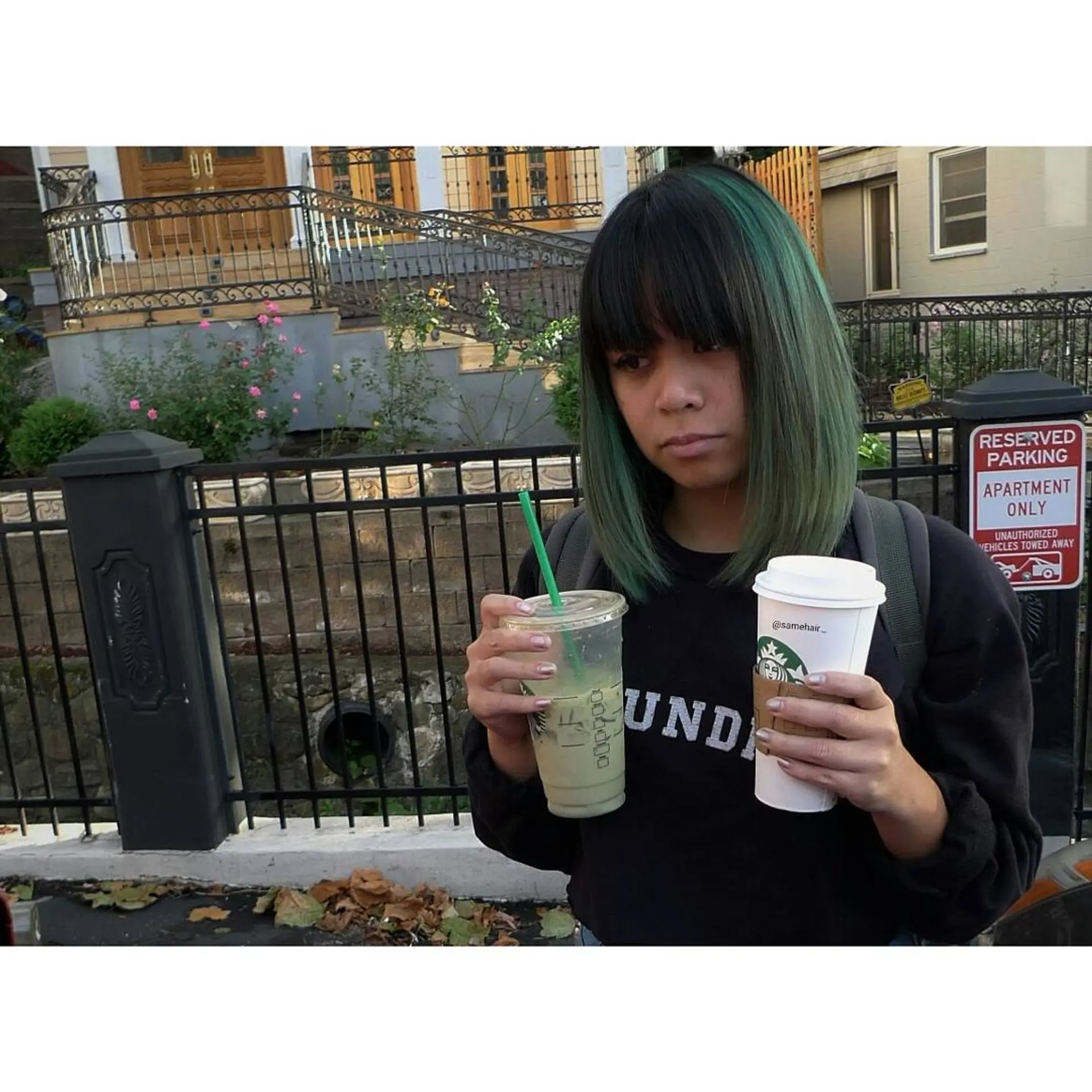 Straight collarbone-length lob paired with blunt bangs and deep forest green highlights. 1
