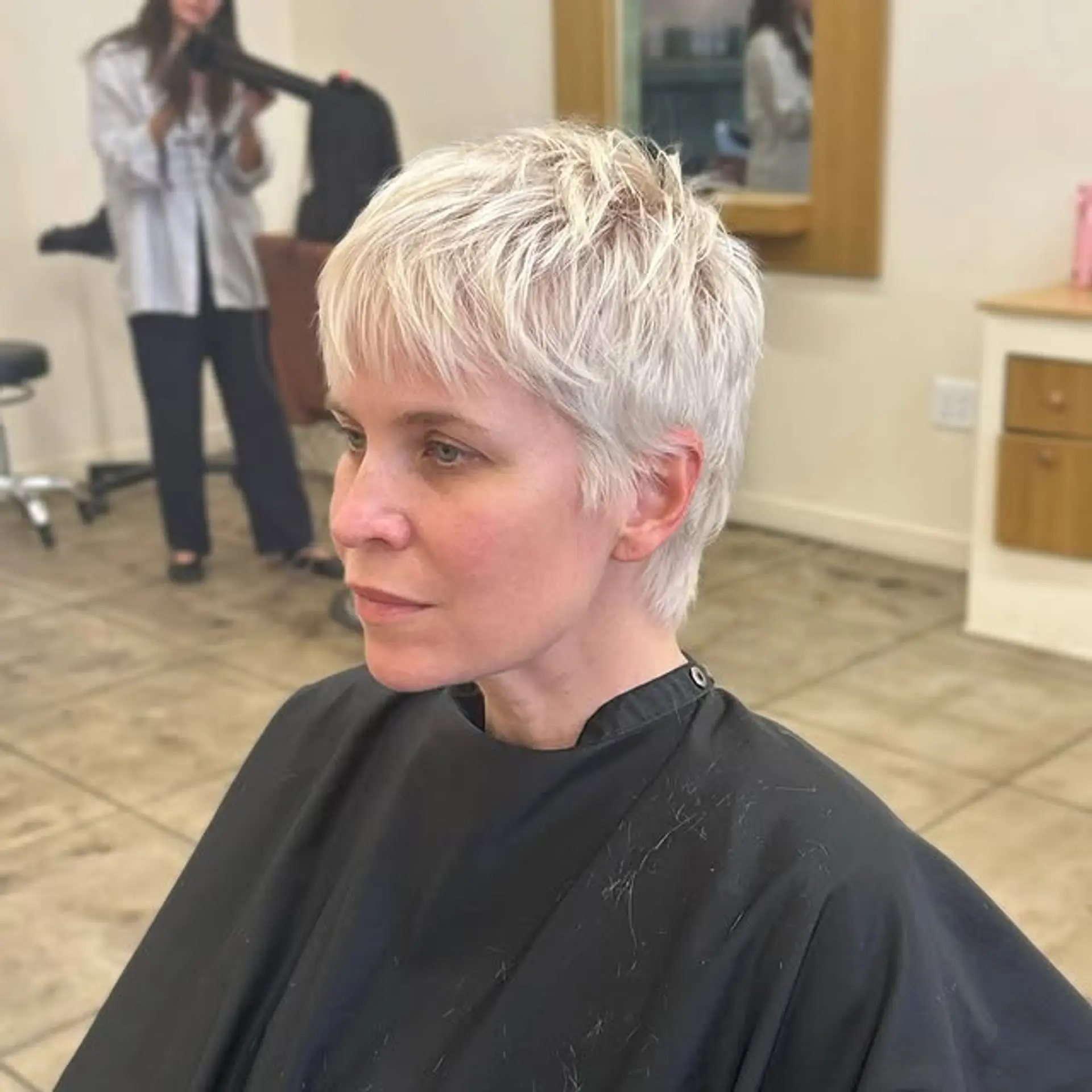 A short, textured pixie cut with choppy layers. 1