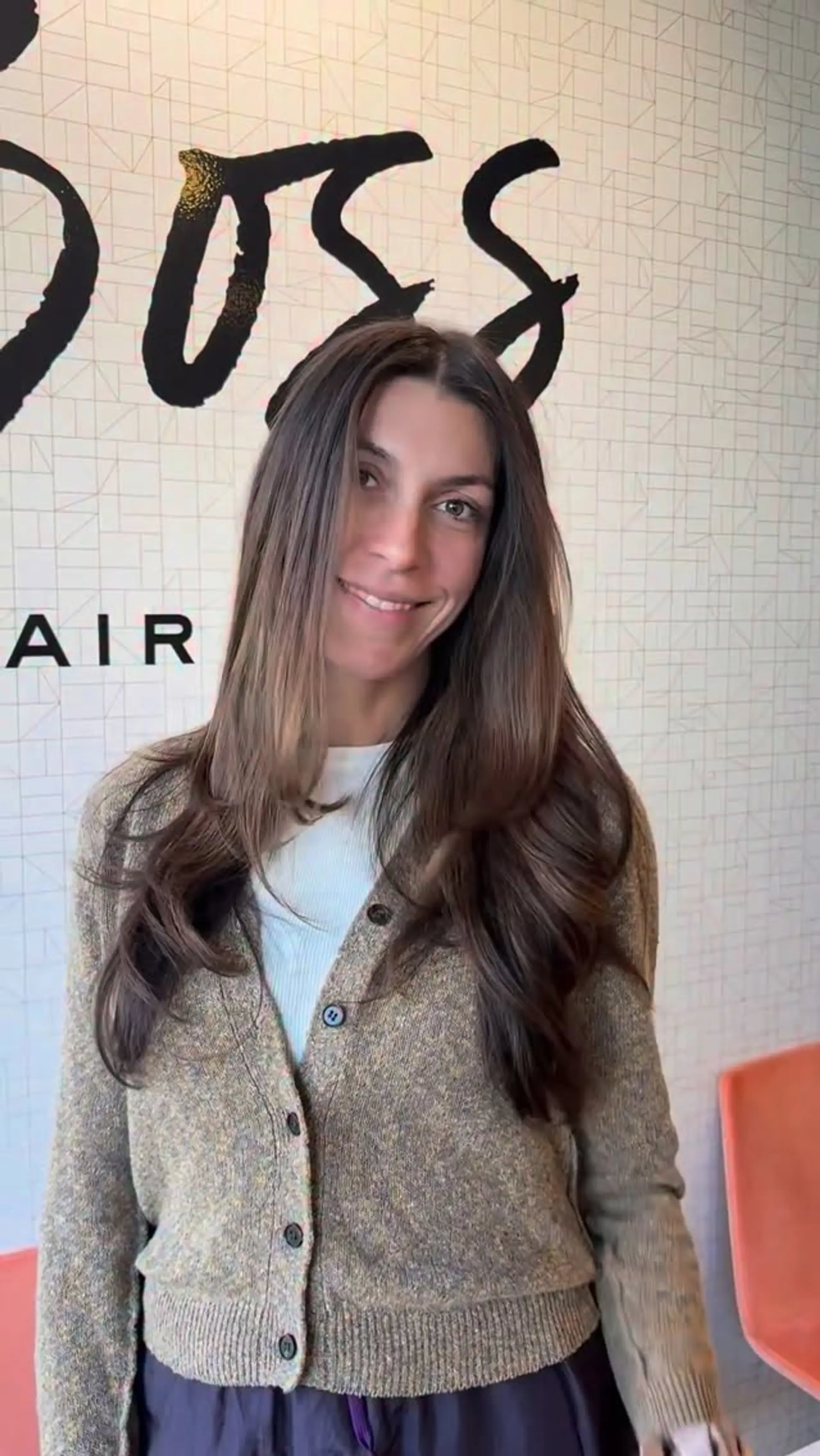 Long layered brunette hair with subtle caramel tones, styled into a smooth blowout with soft curled ends. 1
