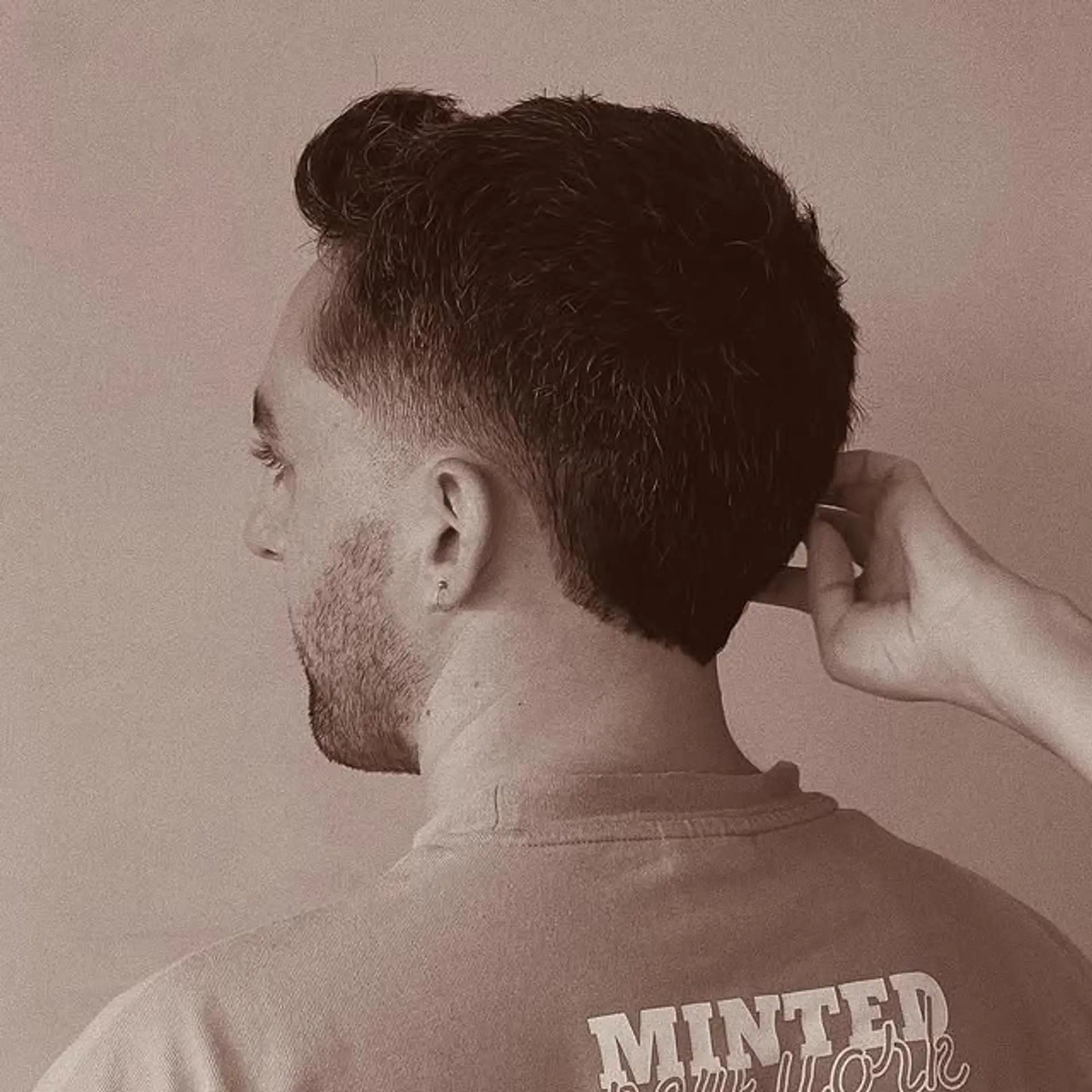 A stylish short haircut with a taper fade and a textured top. 1