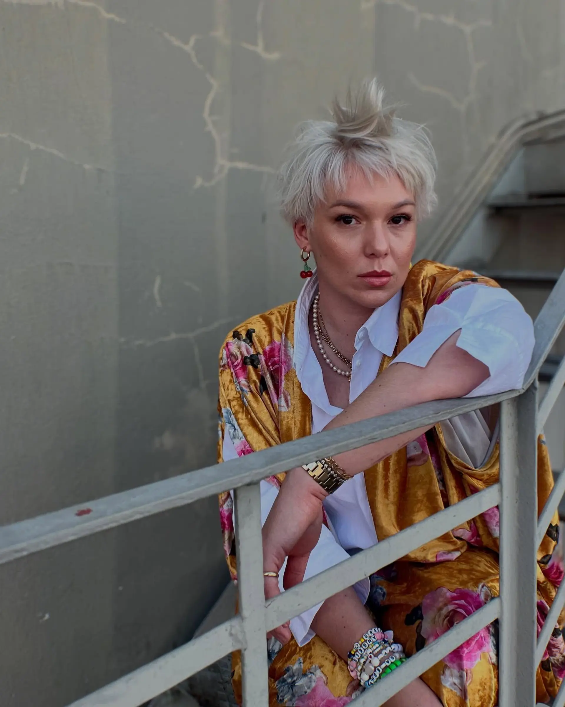 A textured razor-cut platinum pixie cut featuring soft fringe and effortless, piecey dimension. 1