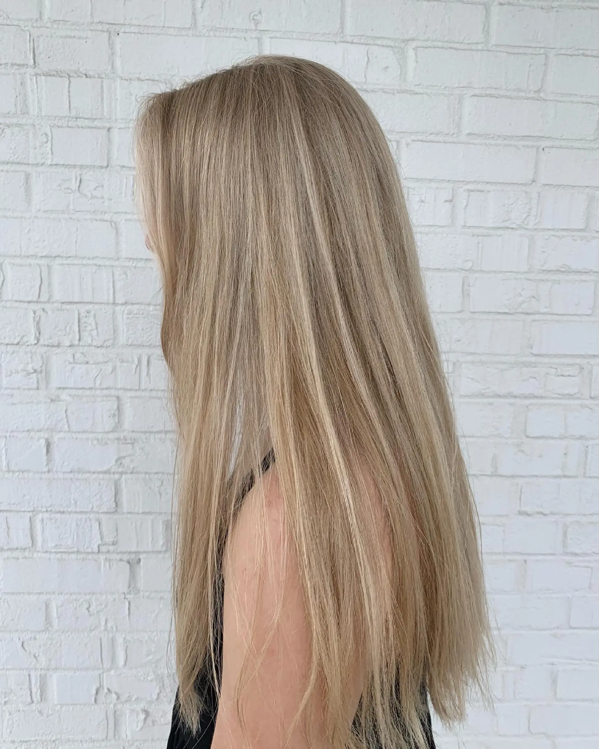 Long, sleek straight hair with bright dimensional blonde highlights throughout. 1