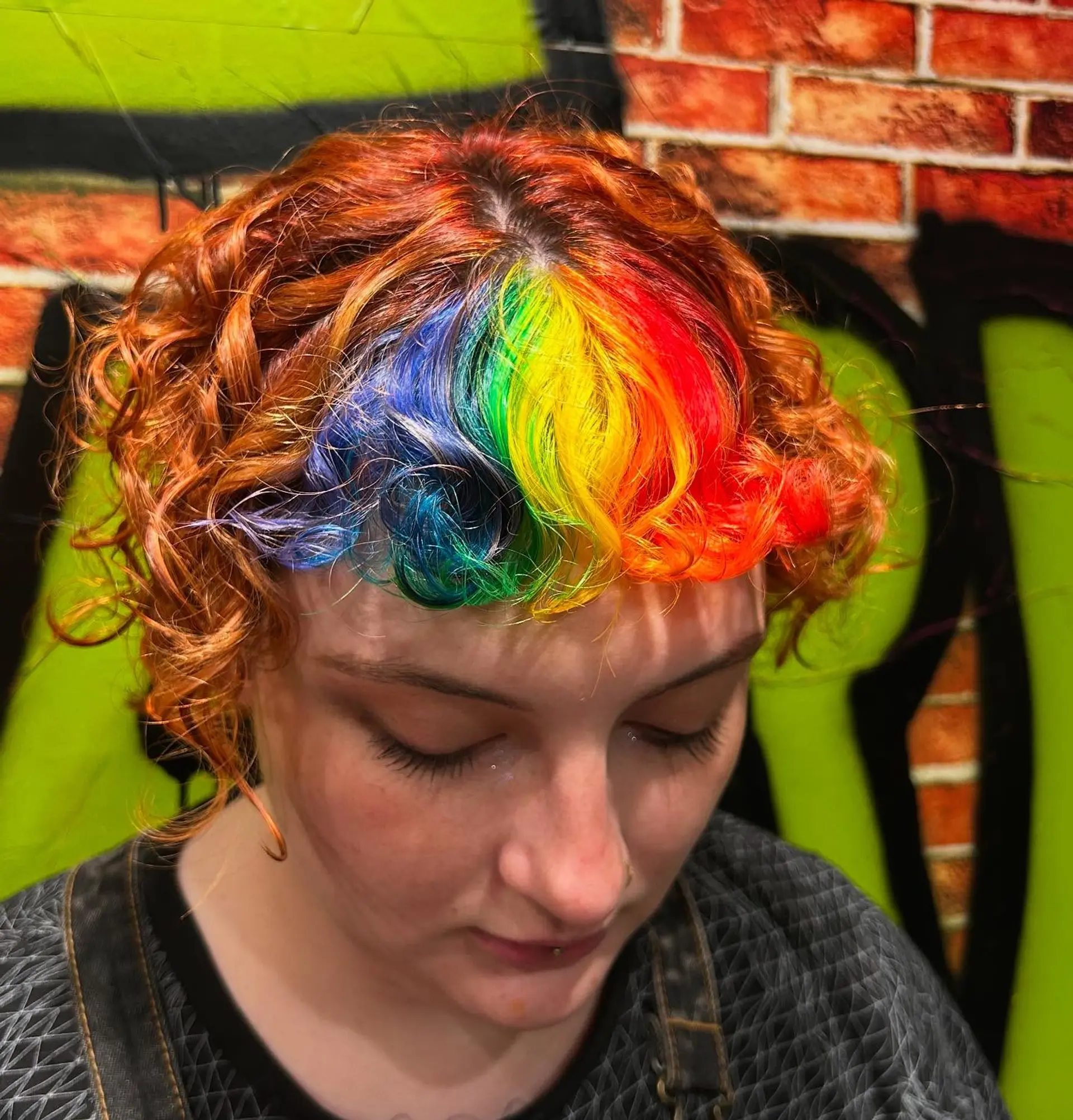 Vibrant rainbow front fringe paired with curly bright copper hair in a short cut. 1