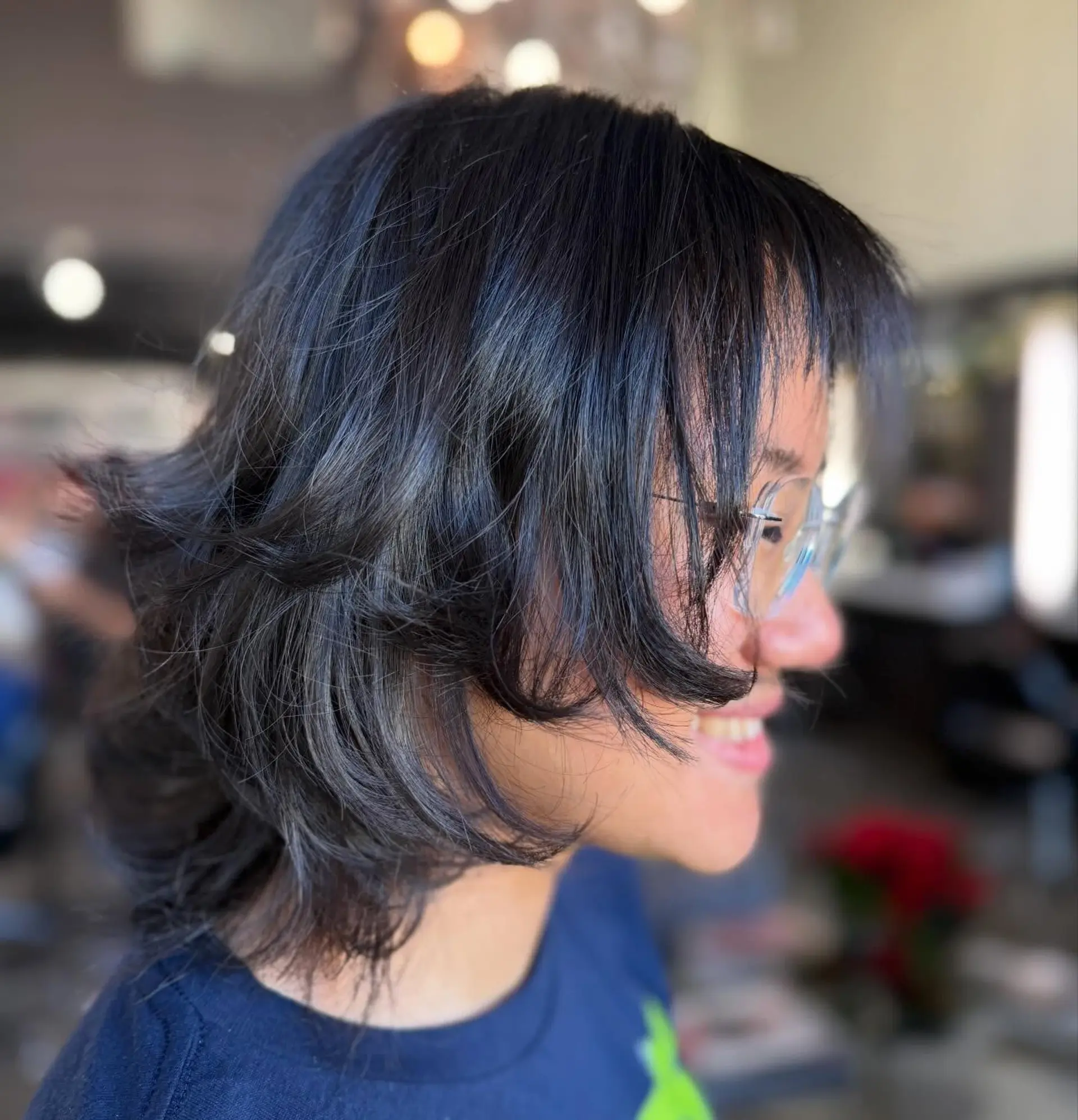 A textured short shag haircut featuring wispy fringe bangs and face-framing, feathered layers with flicked-out ends. 1