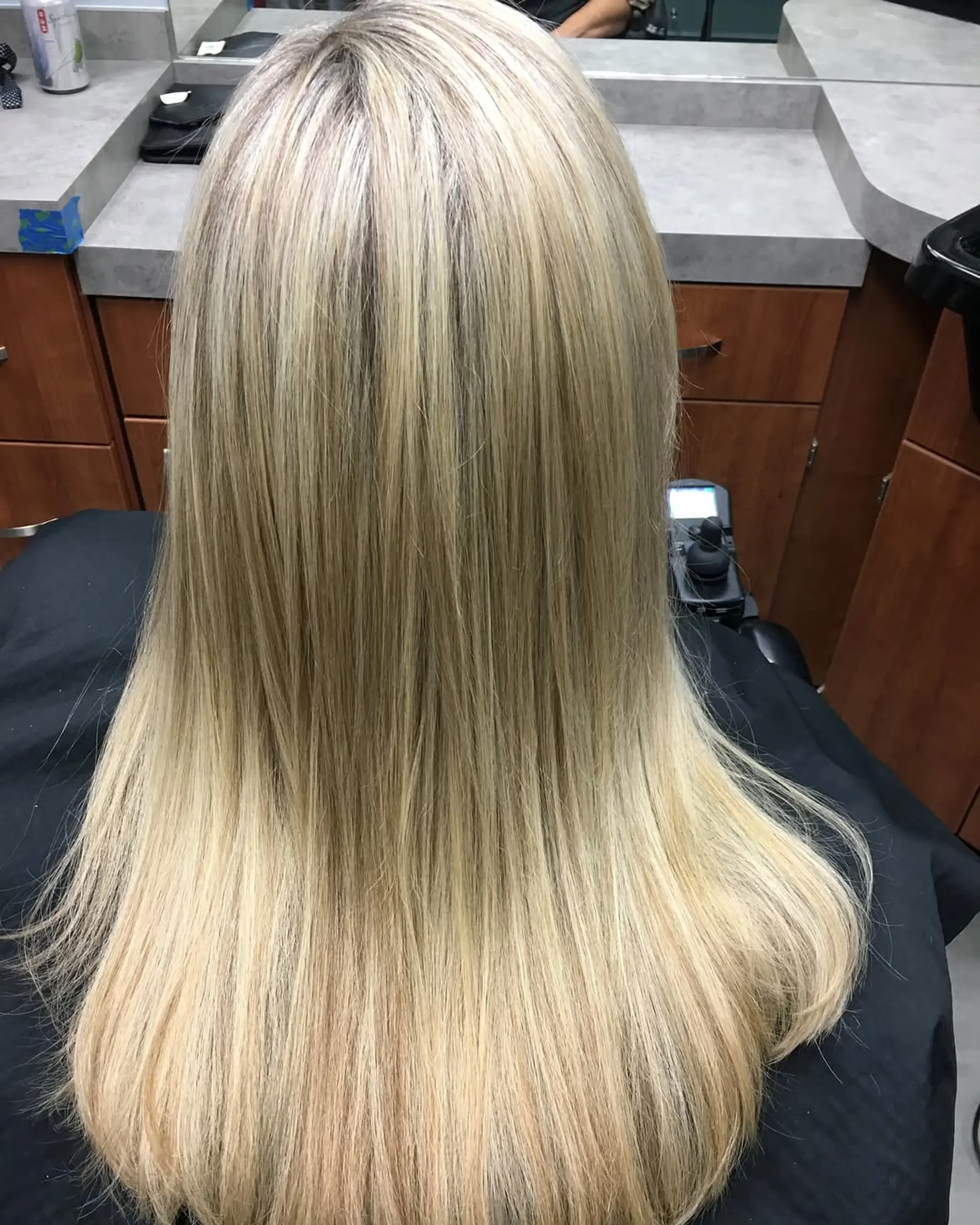 Long, sleek straight blonde hair with fine, multi-tonal highlights seamlessly blended from roots to ends. 1