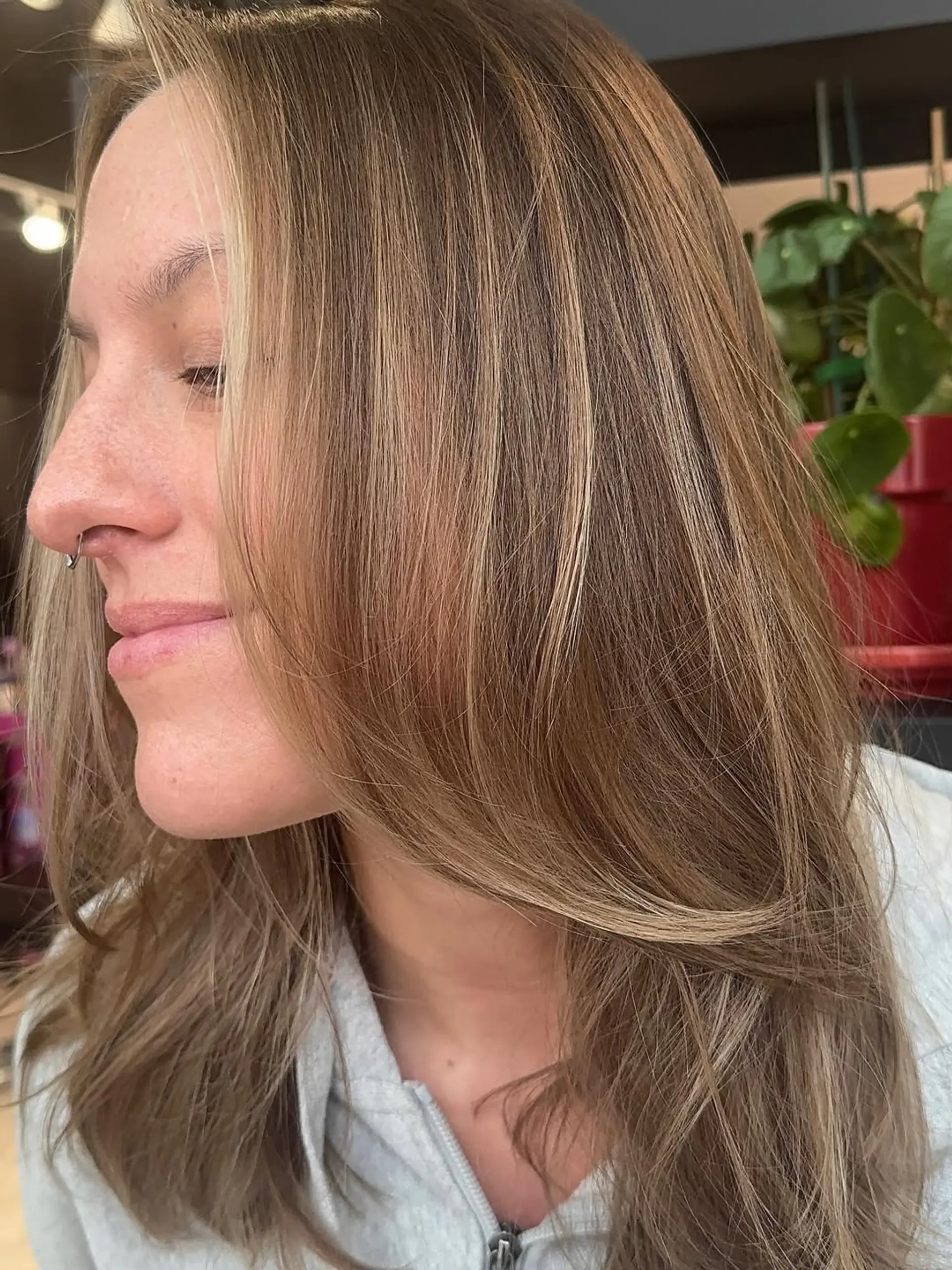 A medium-length, straight hairstyle characterized by a dimensional bronde color, combining light brown with golden blonde and caramel highlights. Soft, face-framing layers add movement and shape. 1