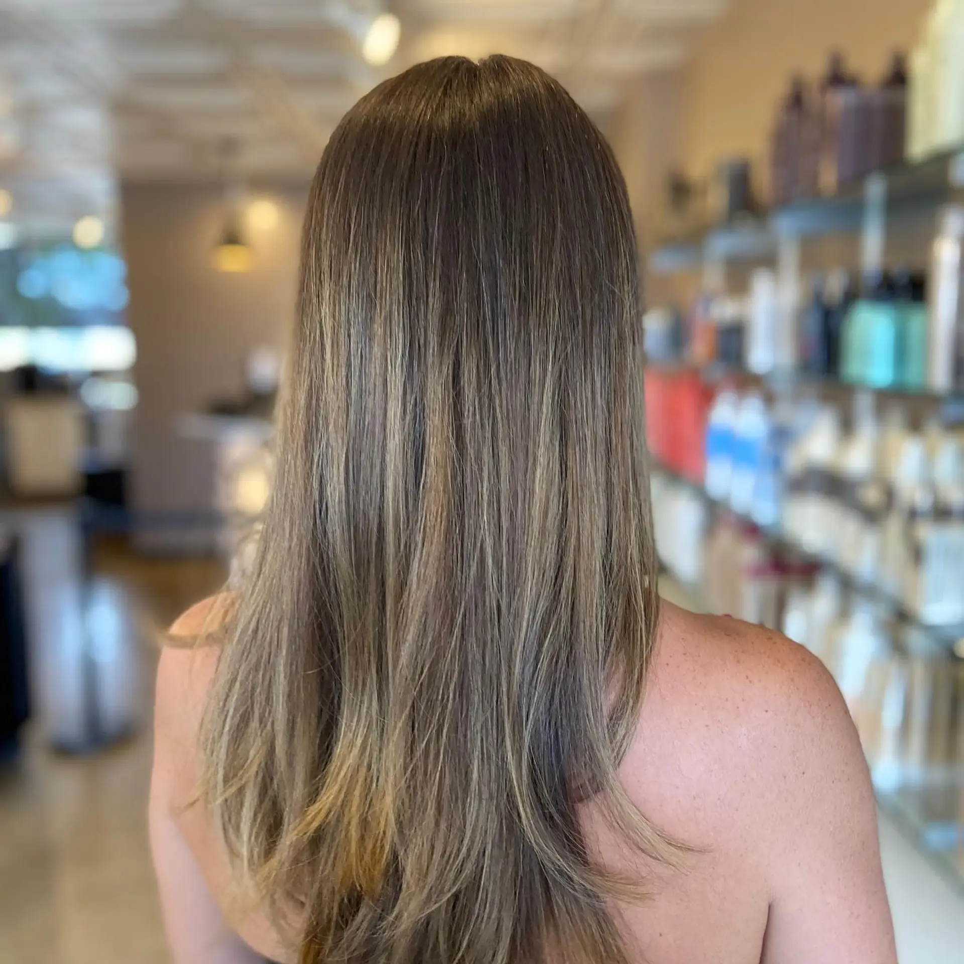 Long straight hair featuring fine dimensional highlights and lowlights for a soft, natural sunkissed finish. 1