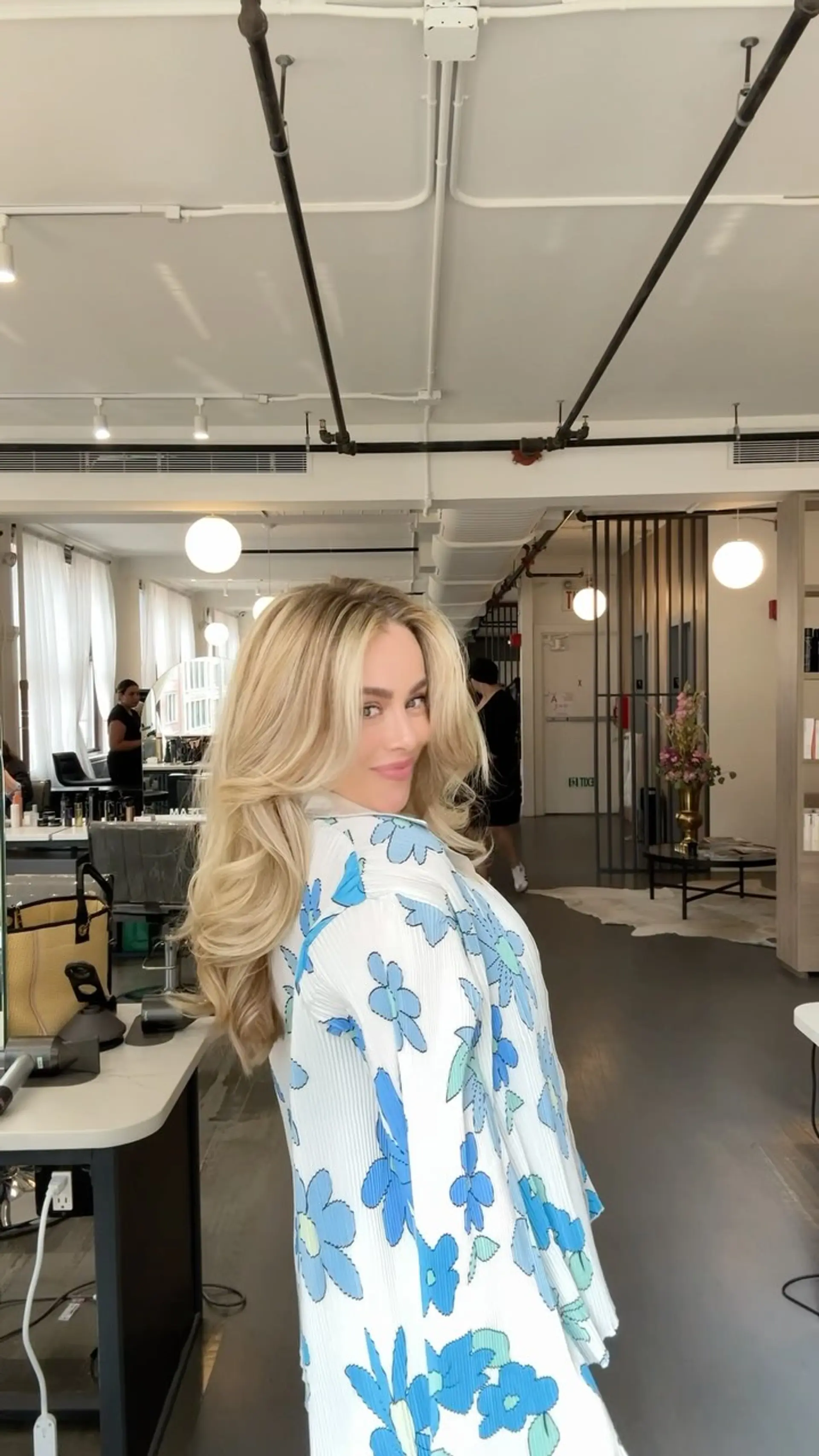 Voluminous long icy blonde hair styled in a bouncy blowout with face-framing layers and curled ends. 1