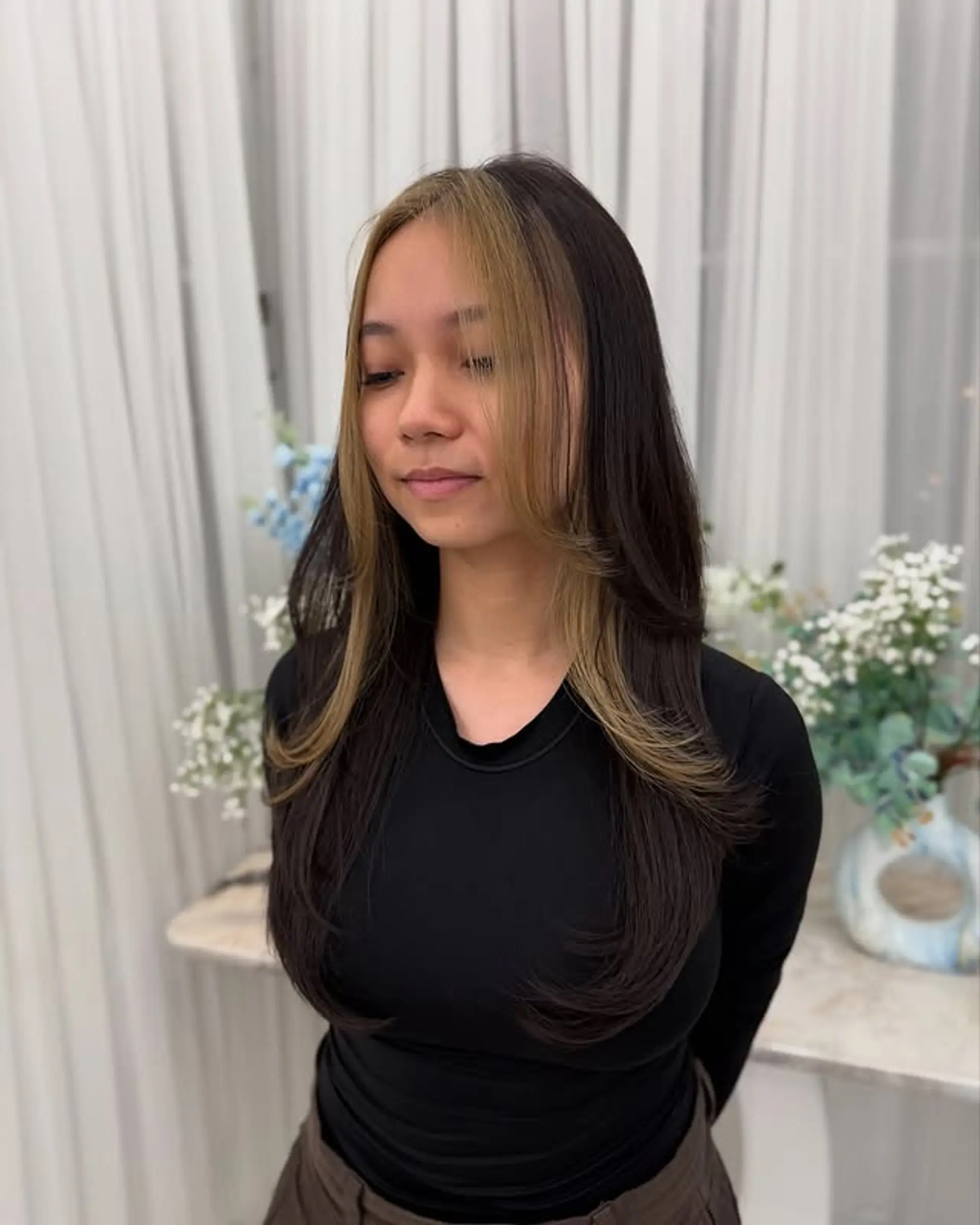 Long layered brunette hairstyle with blonde money piece highlights. 1