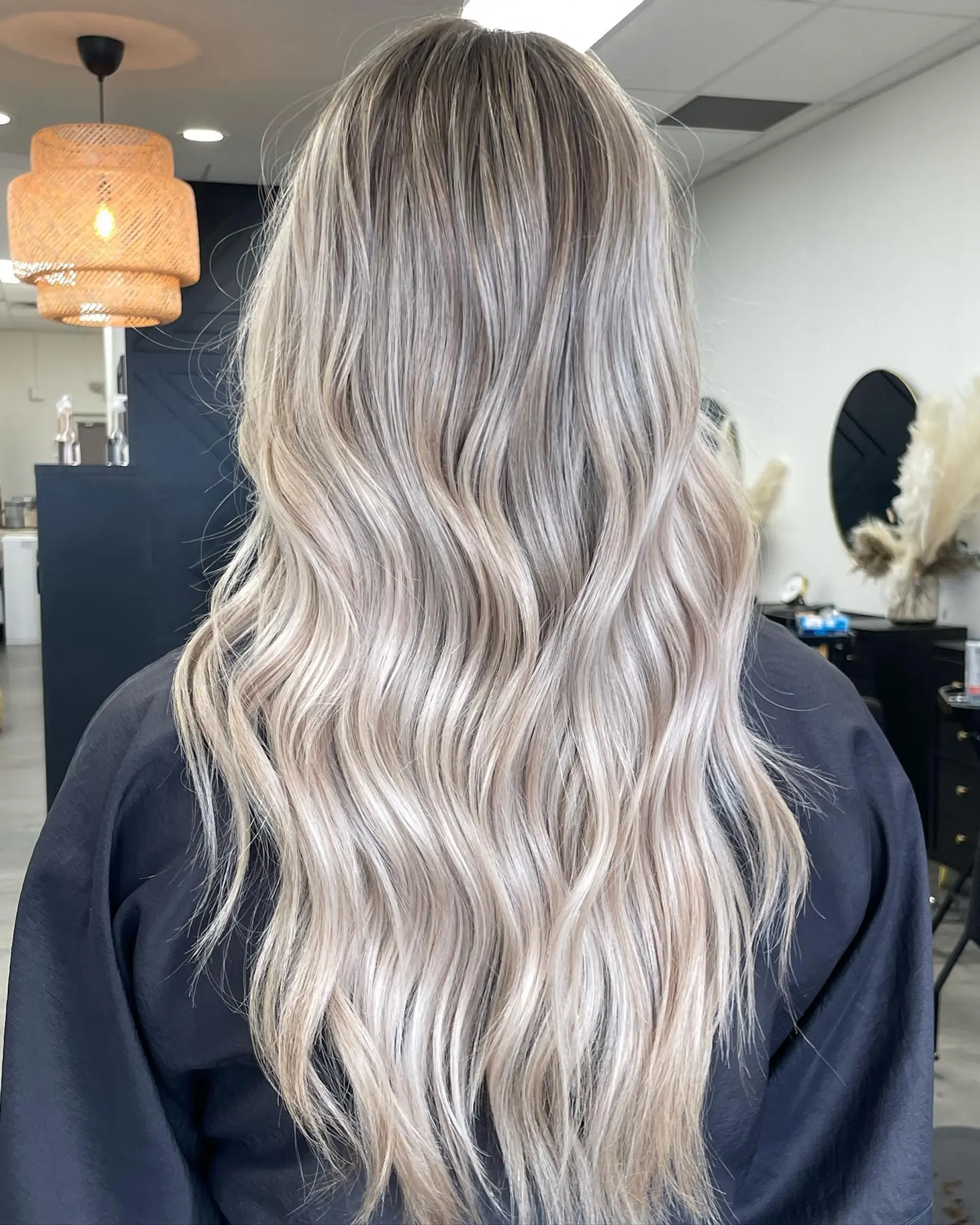 Long beige blonde hair with a blended root melt, styled into soft cascading waves. 1