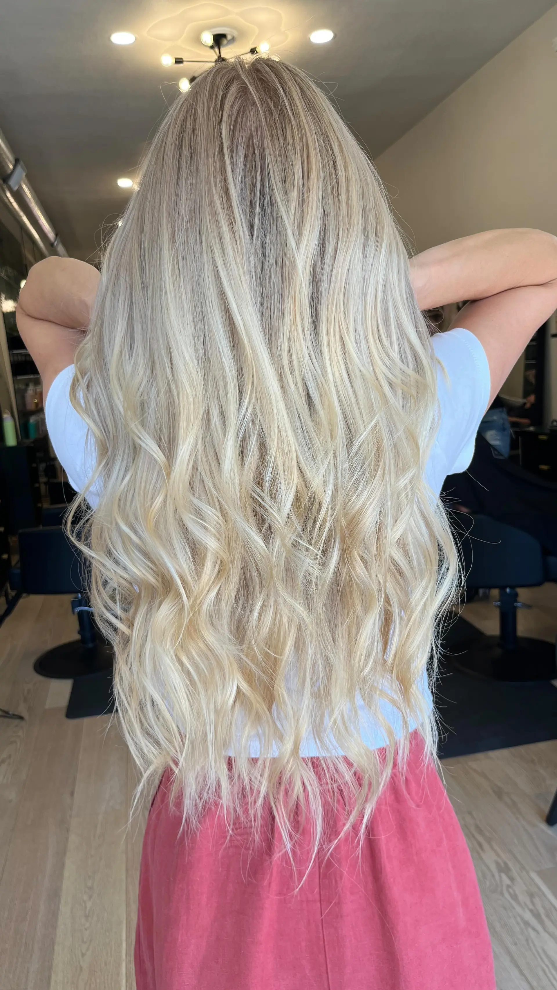 Very long, bright blonde hair styled with soft, cascading beach waves. 1