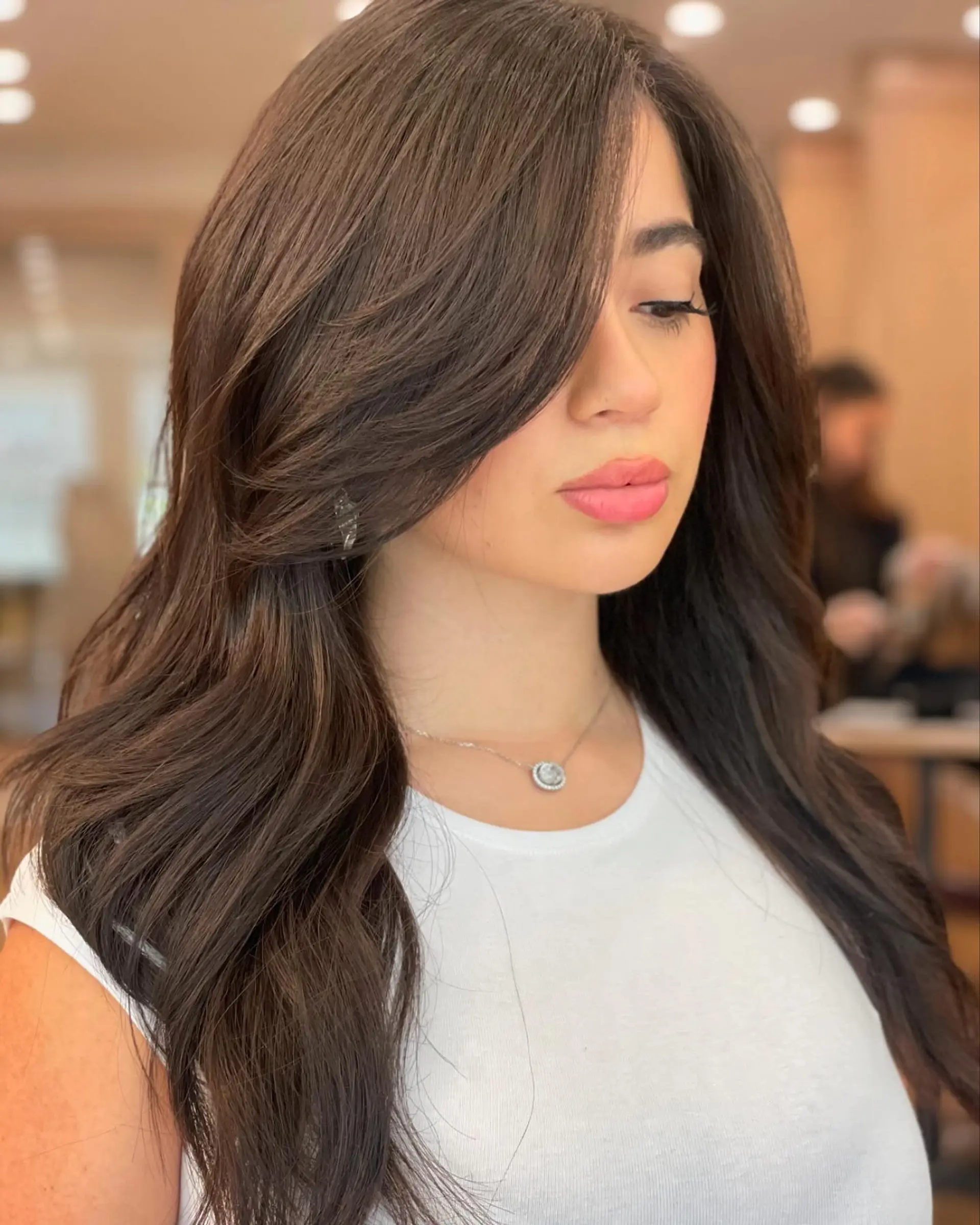 Long layered waves with bronde color and curtain bangs. 2