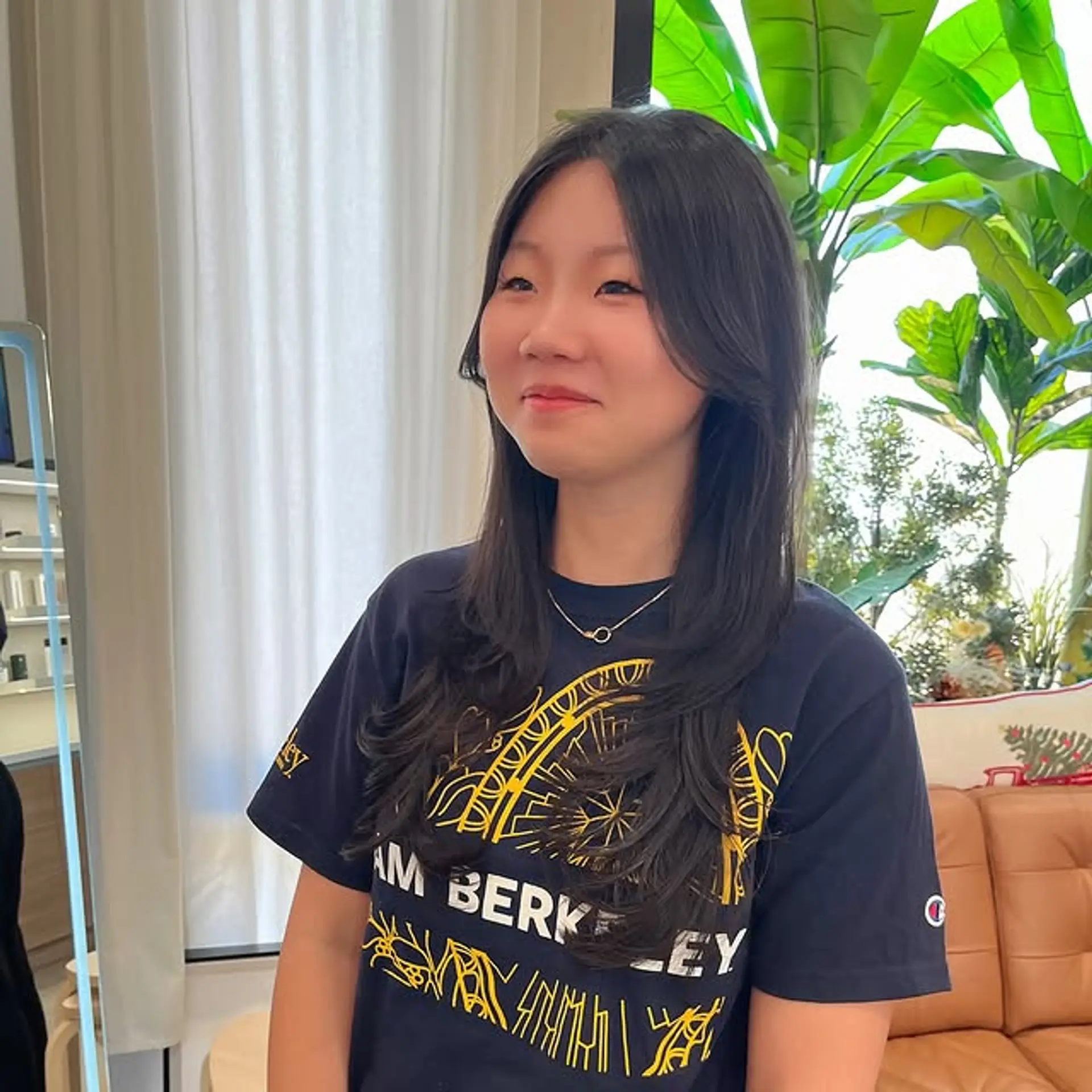 The hair is styled with soft, flowing layers and face-framing pieces. 1