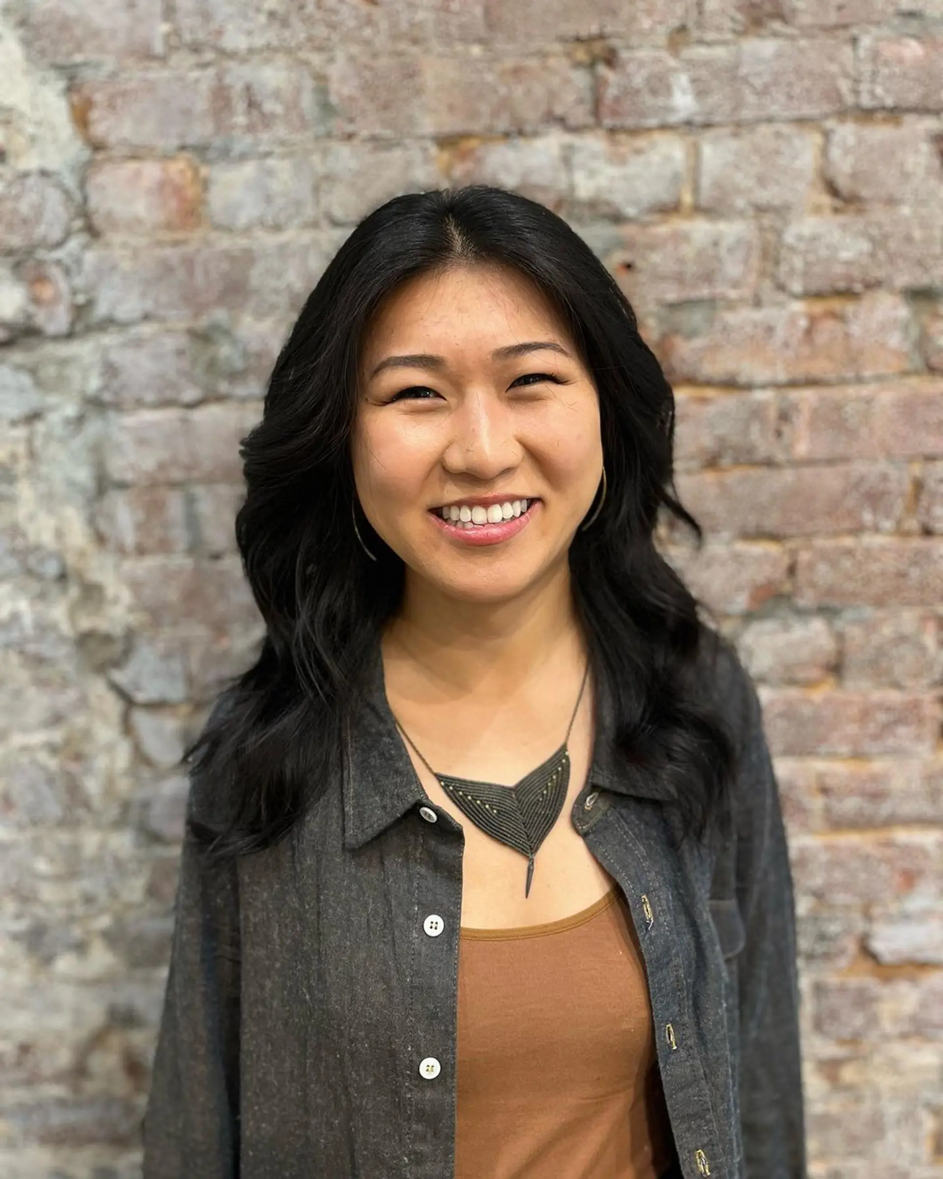 Long, black, wavy hair with a side part, featuring soft, loose waves and a glossy finish. 2