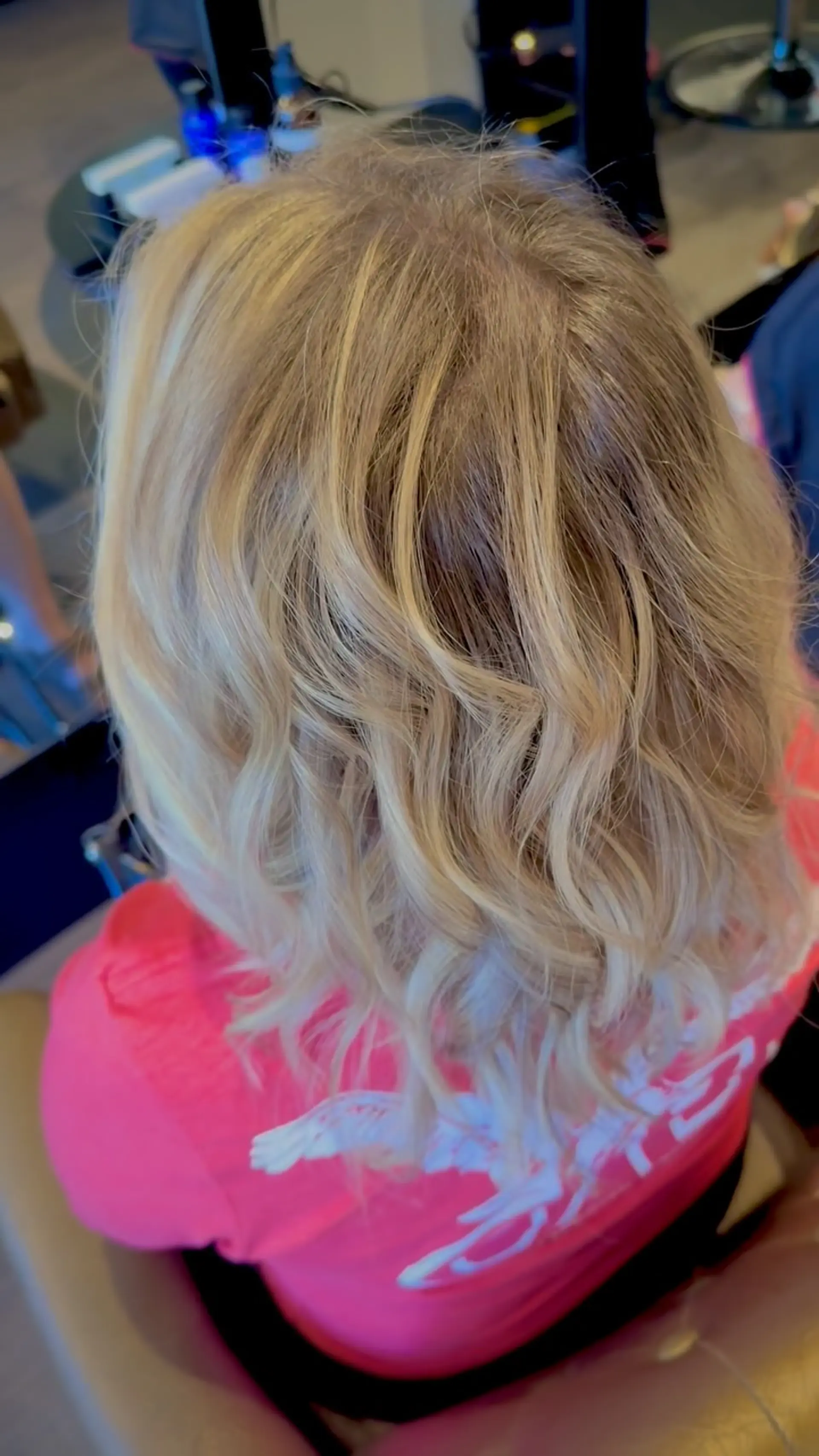 Shoulder-length dimensional blonde hair styled in loose, textured curls. 1