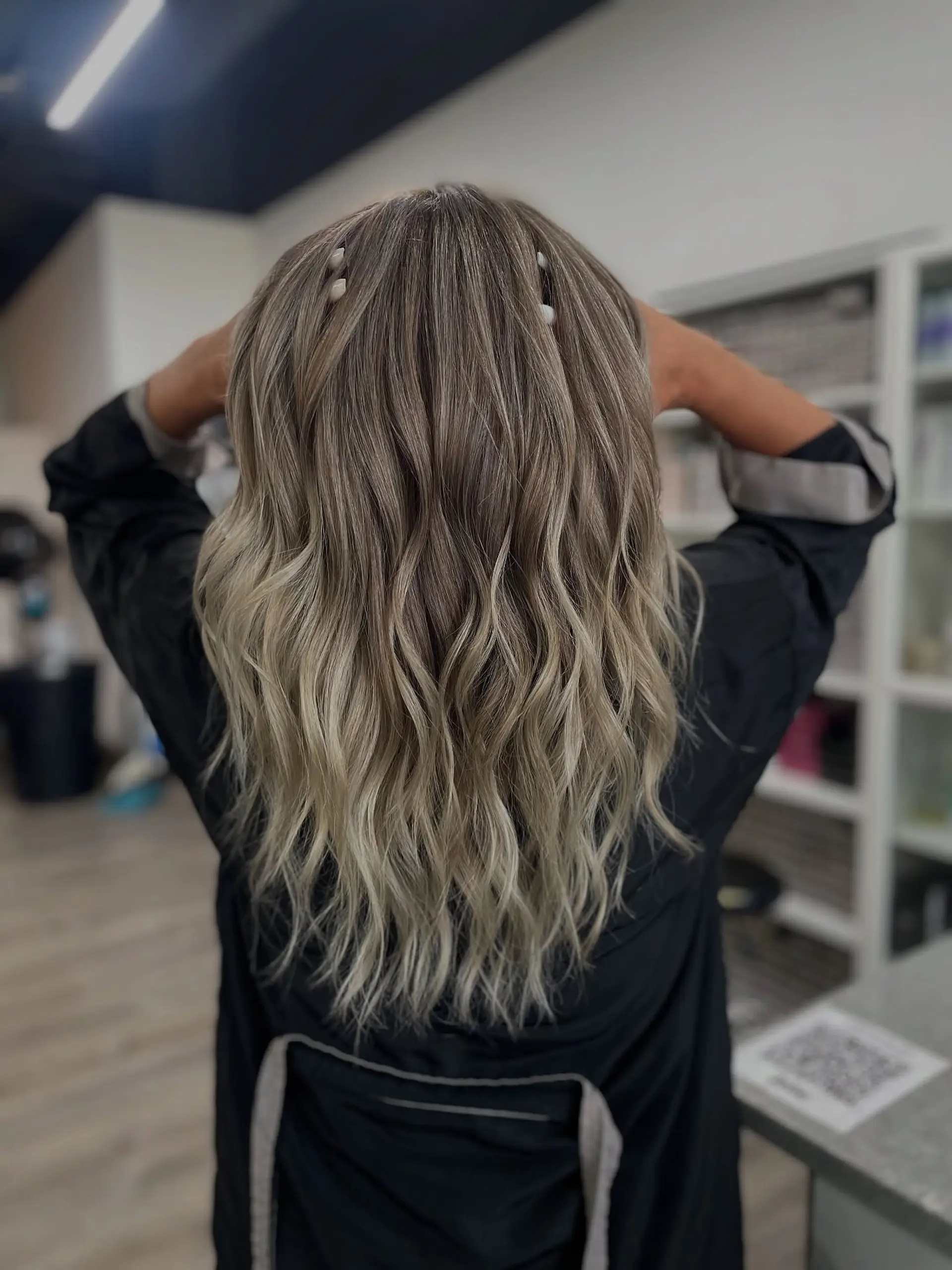 Long, wavy hair with a beachy blonde balayage. 1