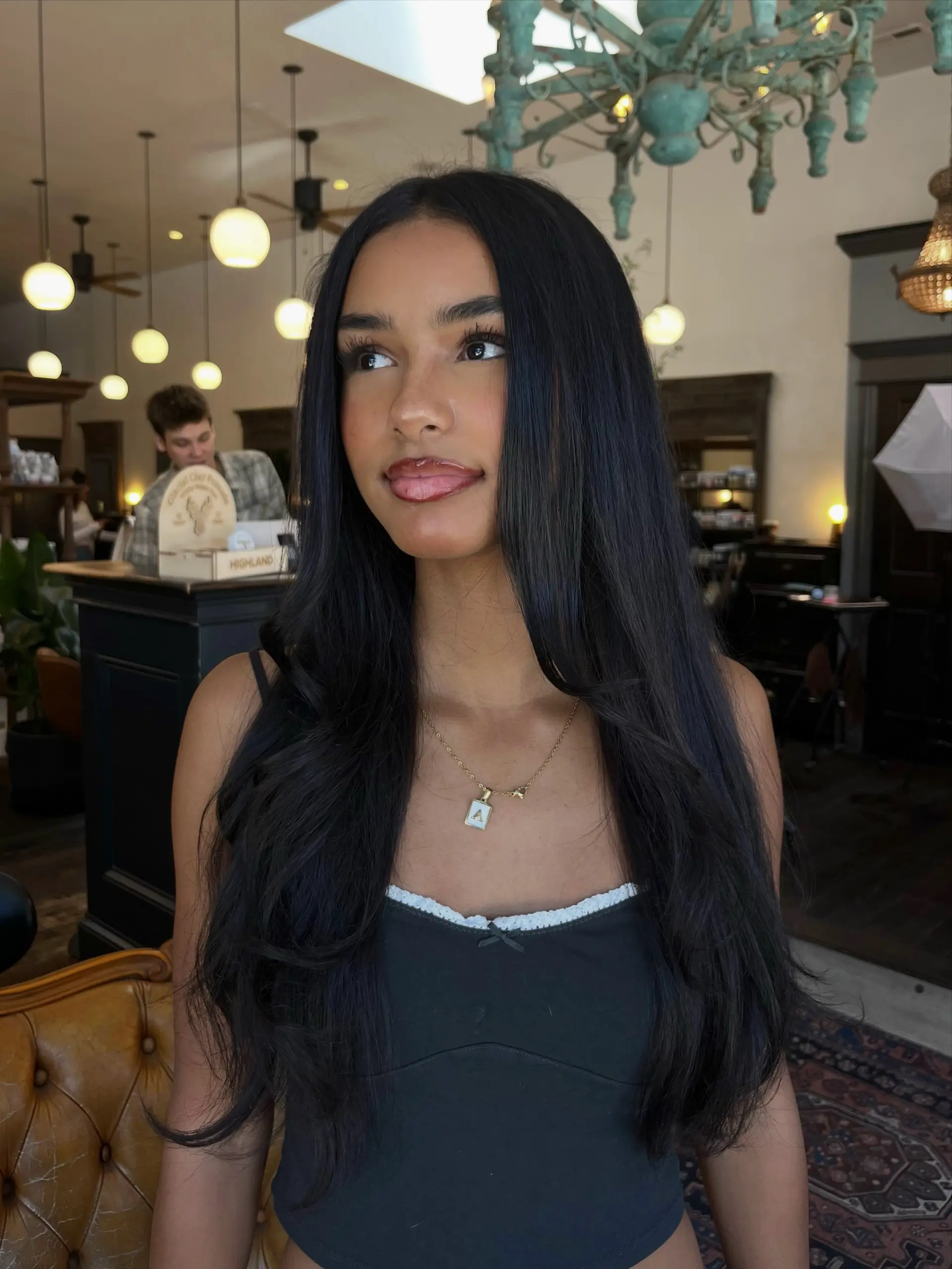 Long, rich dark hair styled into a voluminous blowout with soft outward flips and face-framing layers. 1