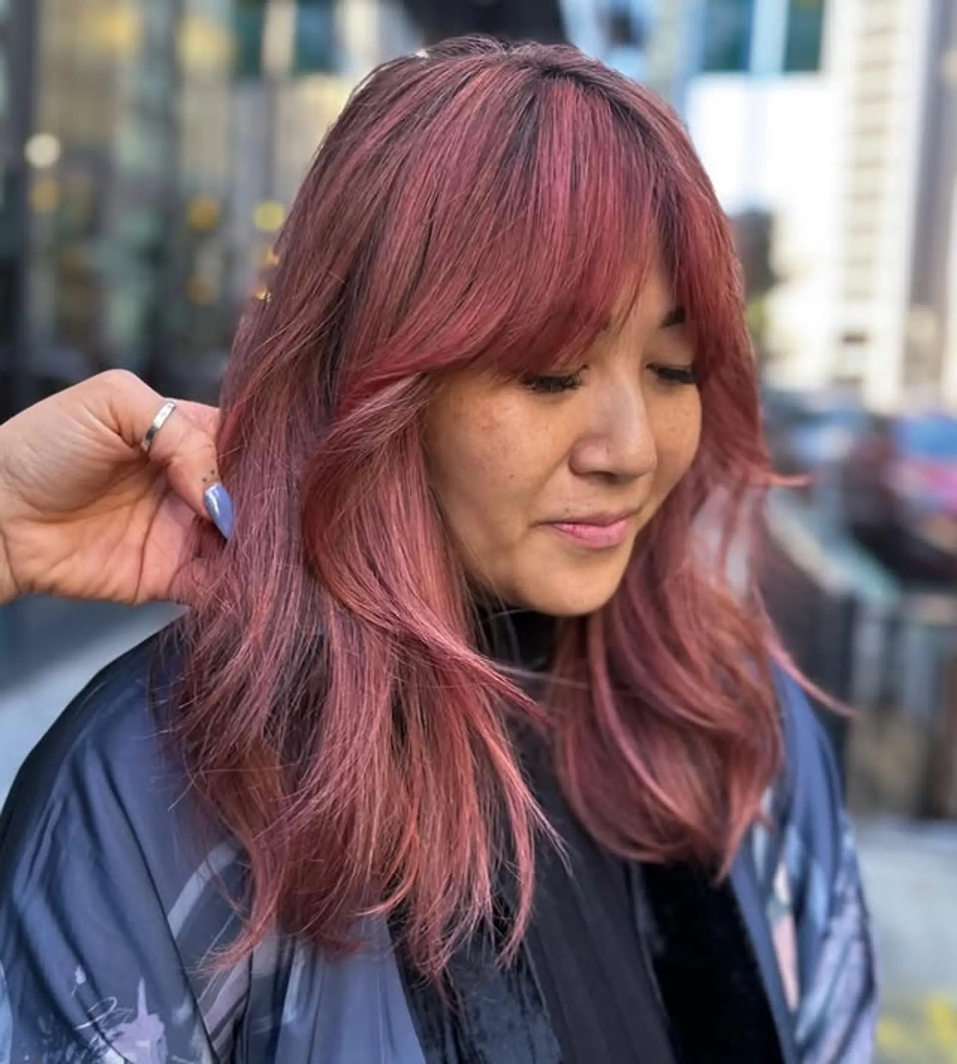 A trendy medium-length wavy shag with face-framing layers and bangs. 1