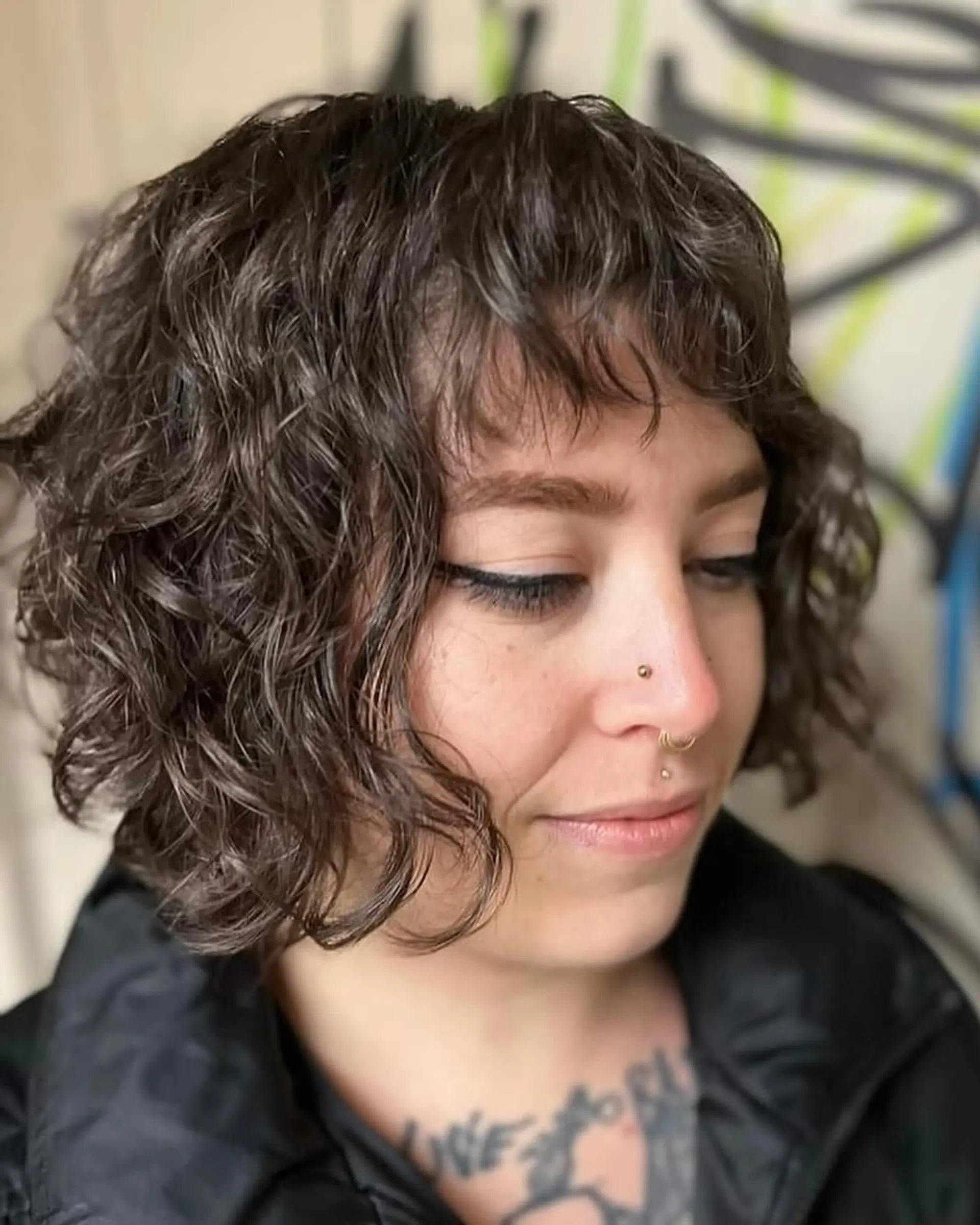 A shaggy, curly bob with bangs, perfect for adding volume and texture. 1