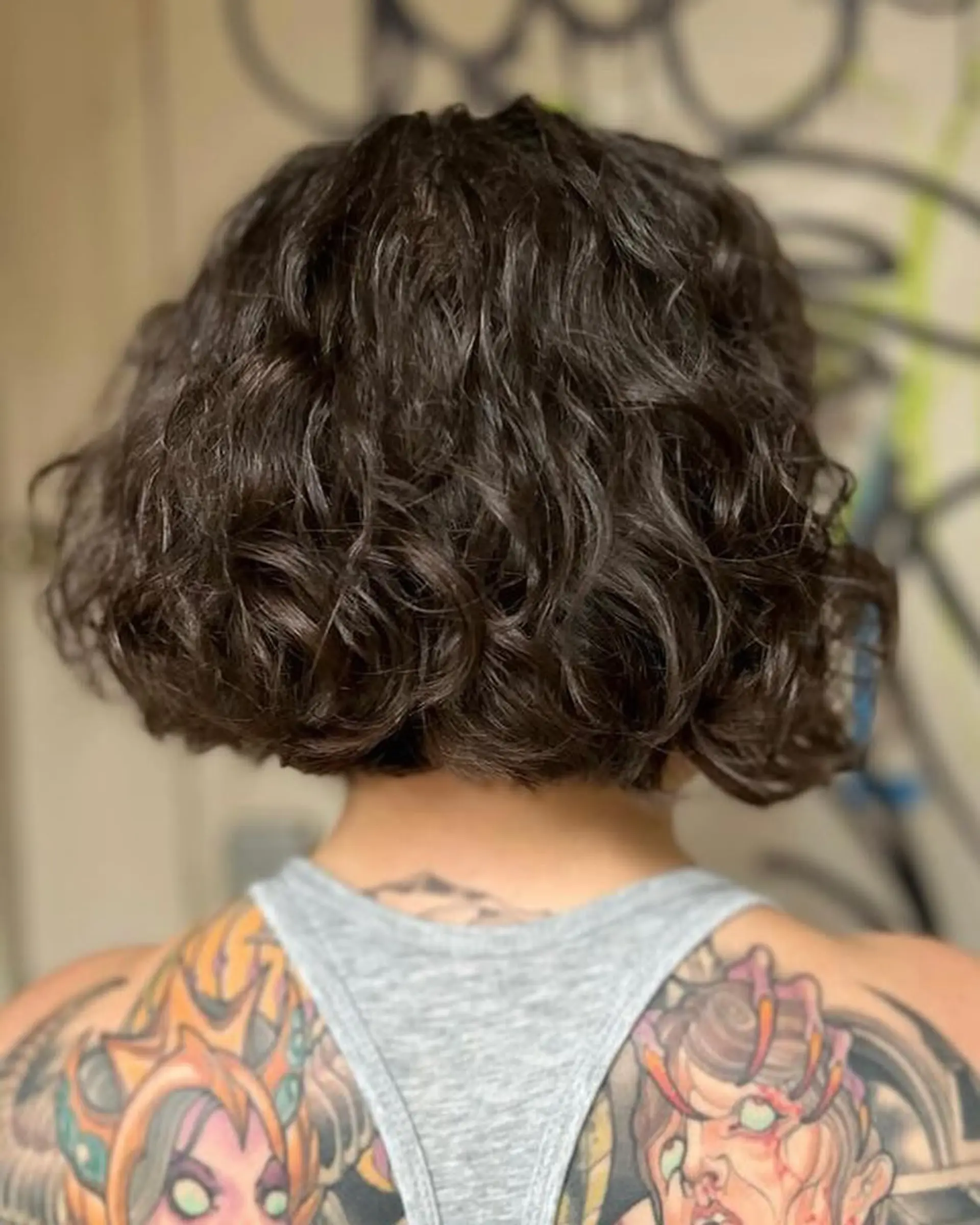 A shaggy, curly bob with bangs, perfect for adding volume and texture. 2