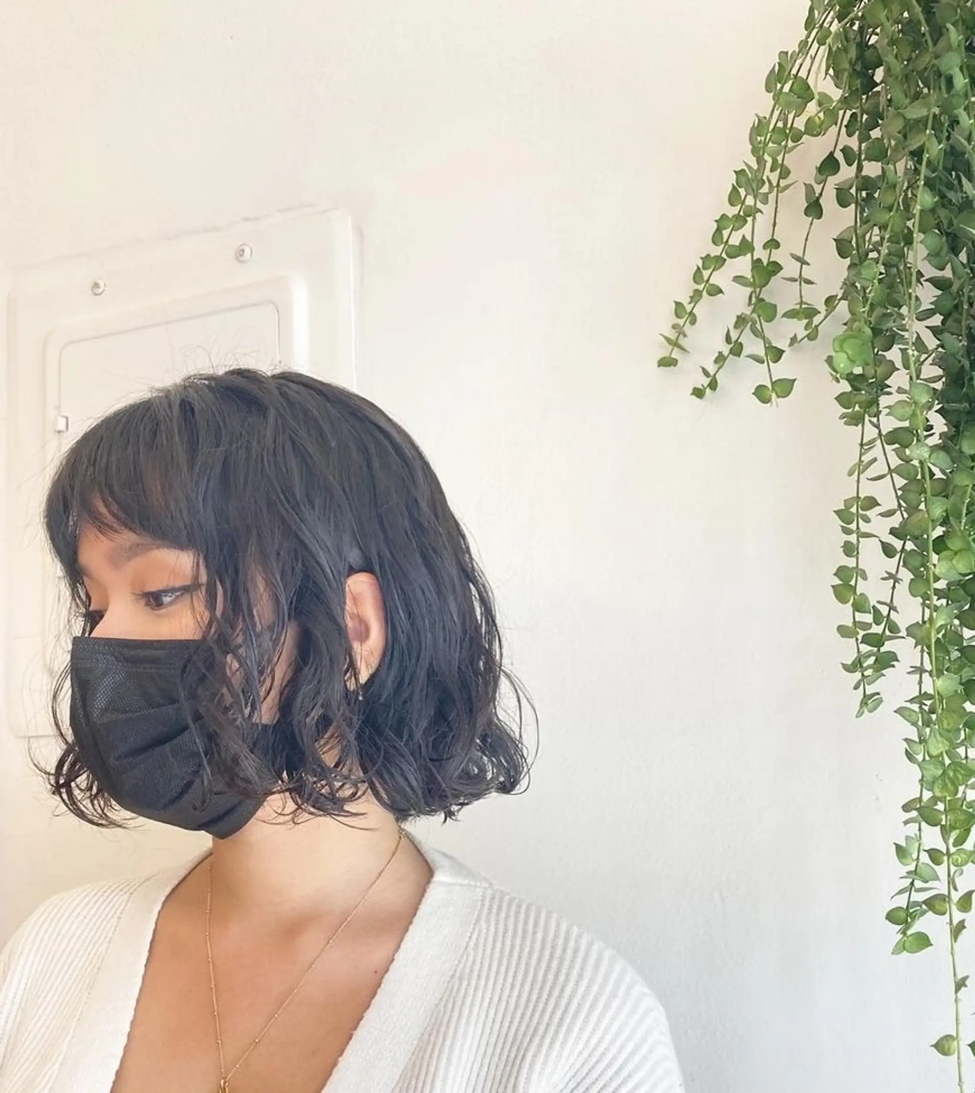 A trendy chin-length bob with soft, natural waves and blunt bangs, giving a fresh and modern look with dark brown hair. 2