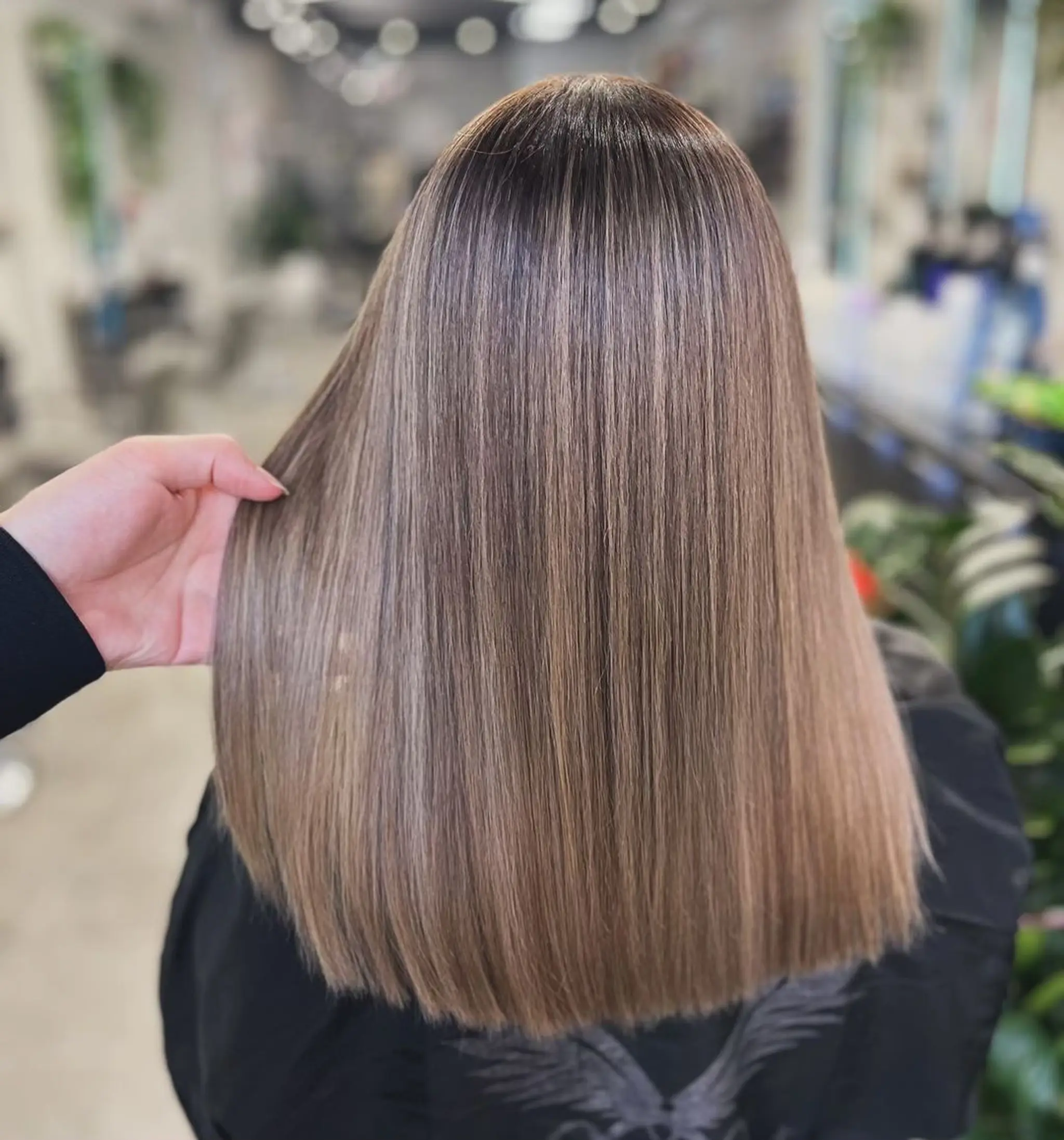A sleek light brown medium-length lob with a straight texture and glossy finish.
Stylist - @xcellent_jason