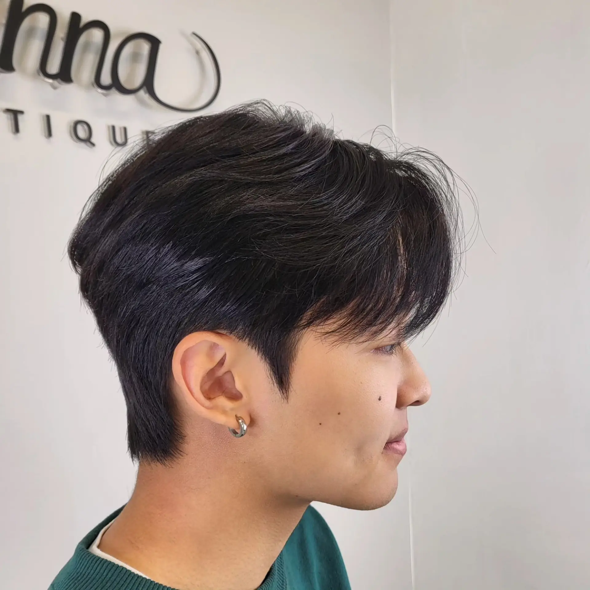 A clean layered short haircut featuring tapered sides and soft textured layers on top with a light fringe. 1