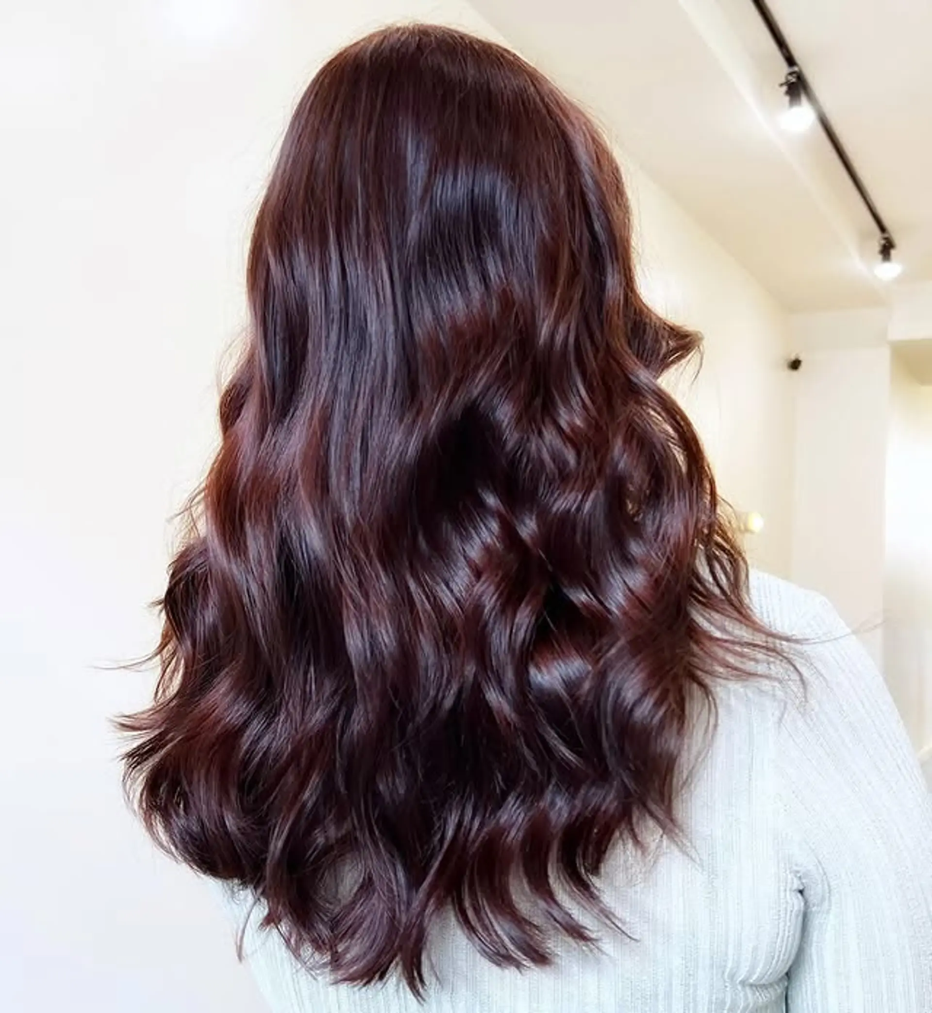 Long, wavy hair with a burgundy color and glossy finish. 1