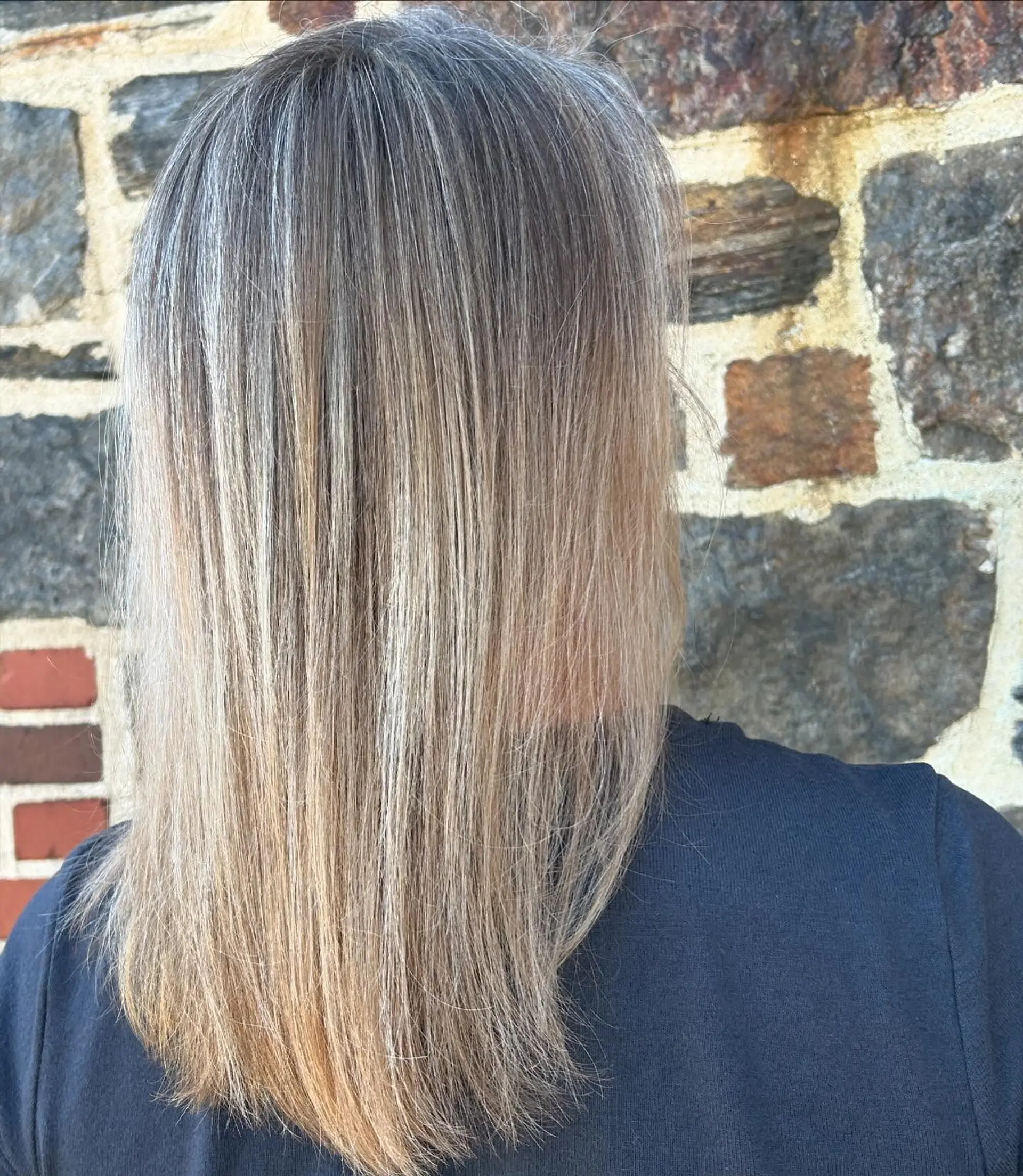 Straight below-shoulder hair featuring seamless, fine blonde babylights blended into a cool ash base. 1