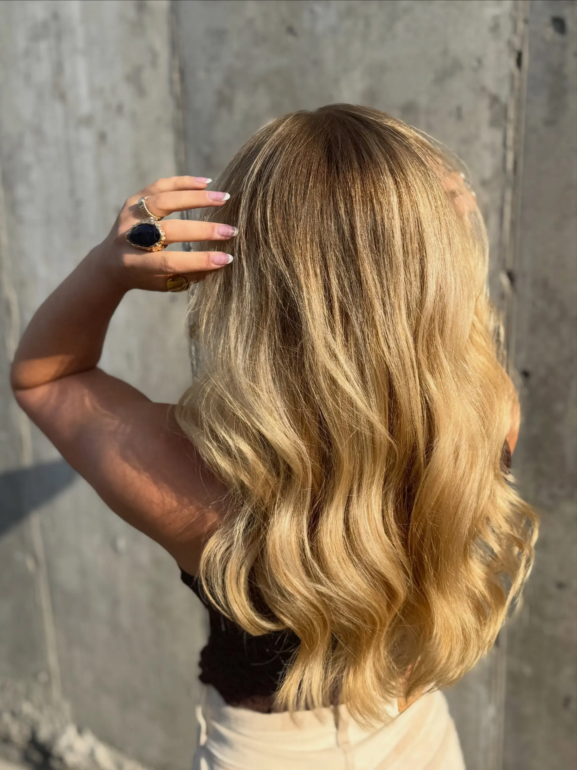 Long dimensional golden blonde hair styled in effortless, flowing waves. 1