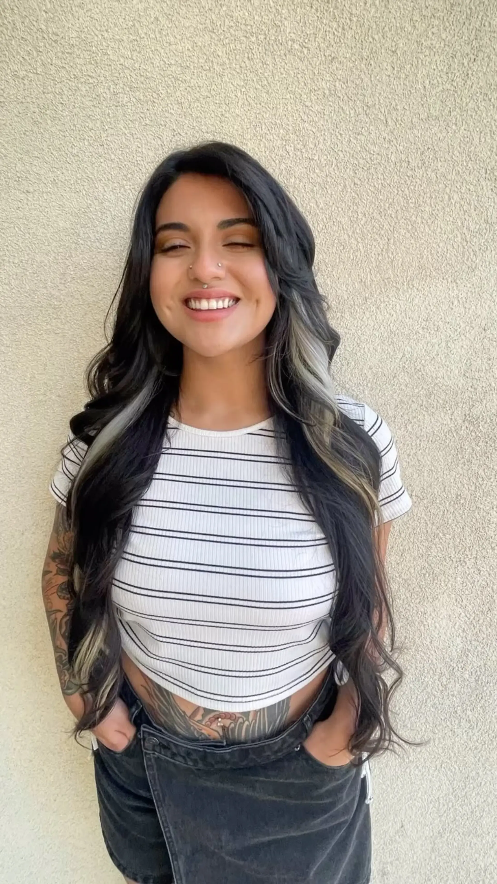 Very long dark hair styled in soft, cascading waves with striking platinum blonde color-block panels underneath. 1