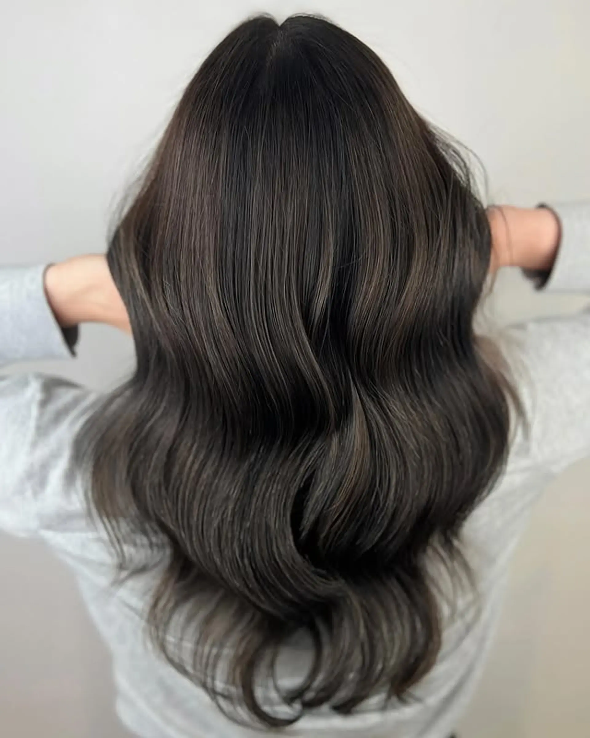 A long, wavy hairstyle with a chocolate swirl balayage. 1