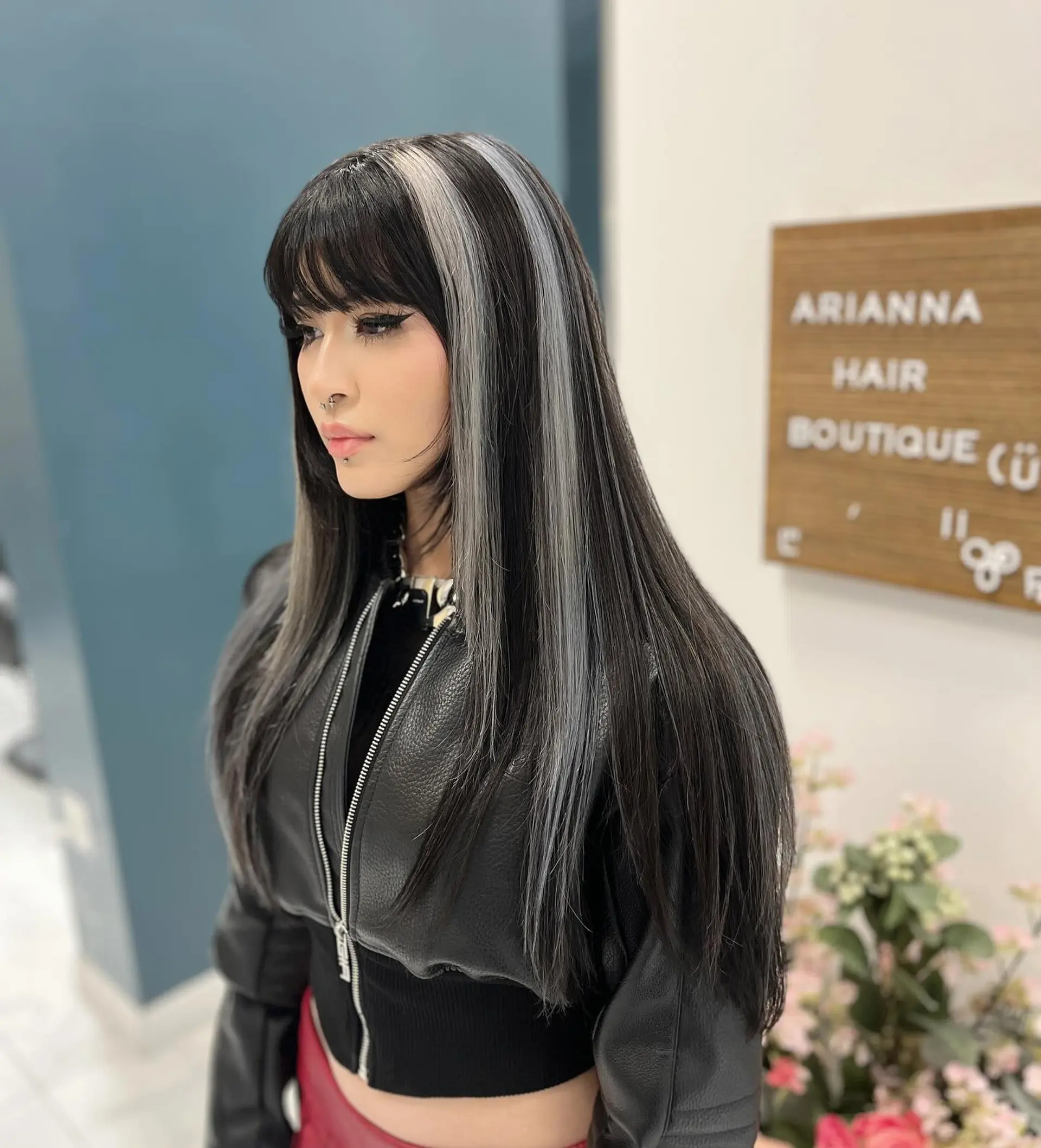 Long sleek black hair styled straight with high-contrast chunky silver-platinum highlight streaks and front bangs. 1