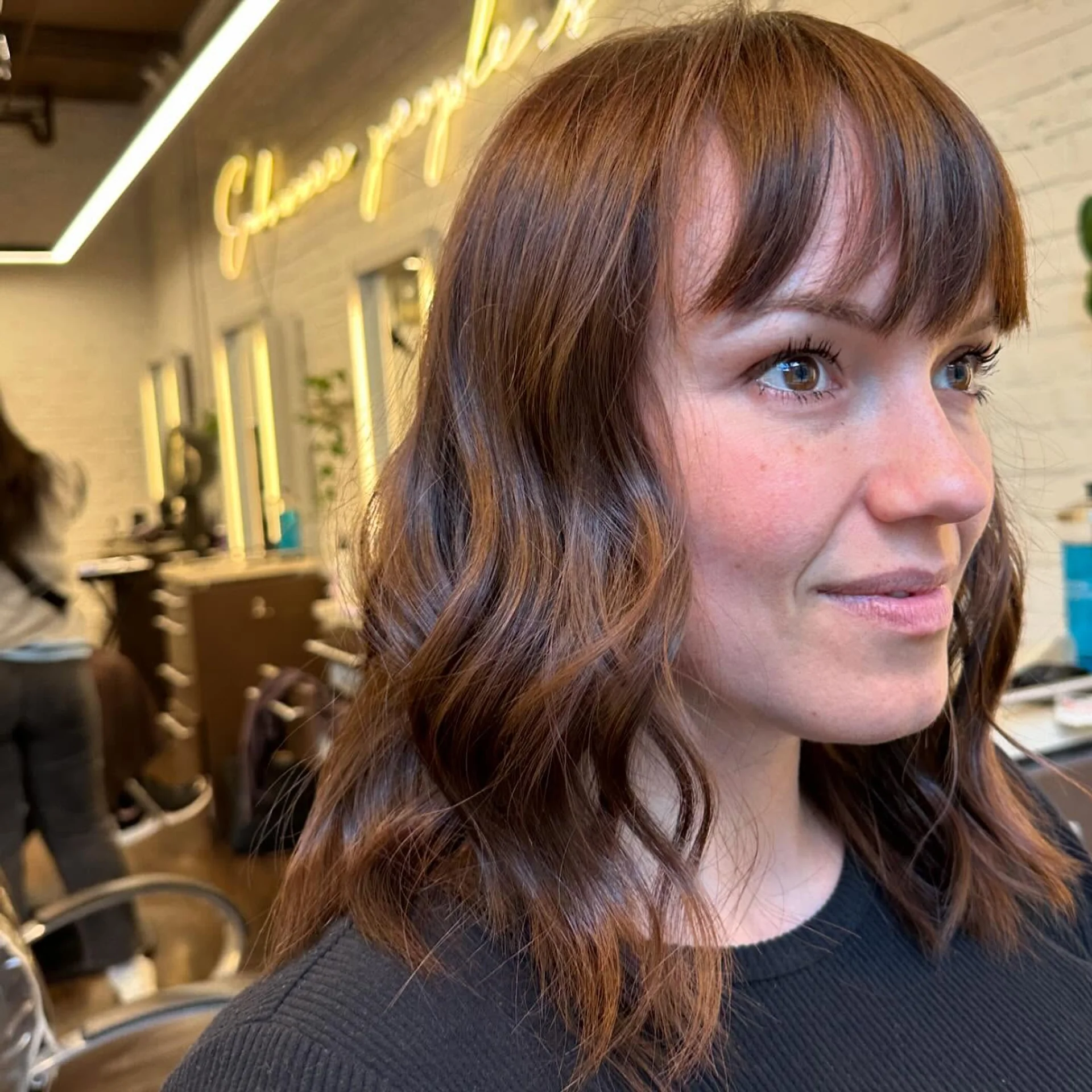 Model showcasing a modern shag haircut with soft, face-framing curtain bangs - Preview 3